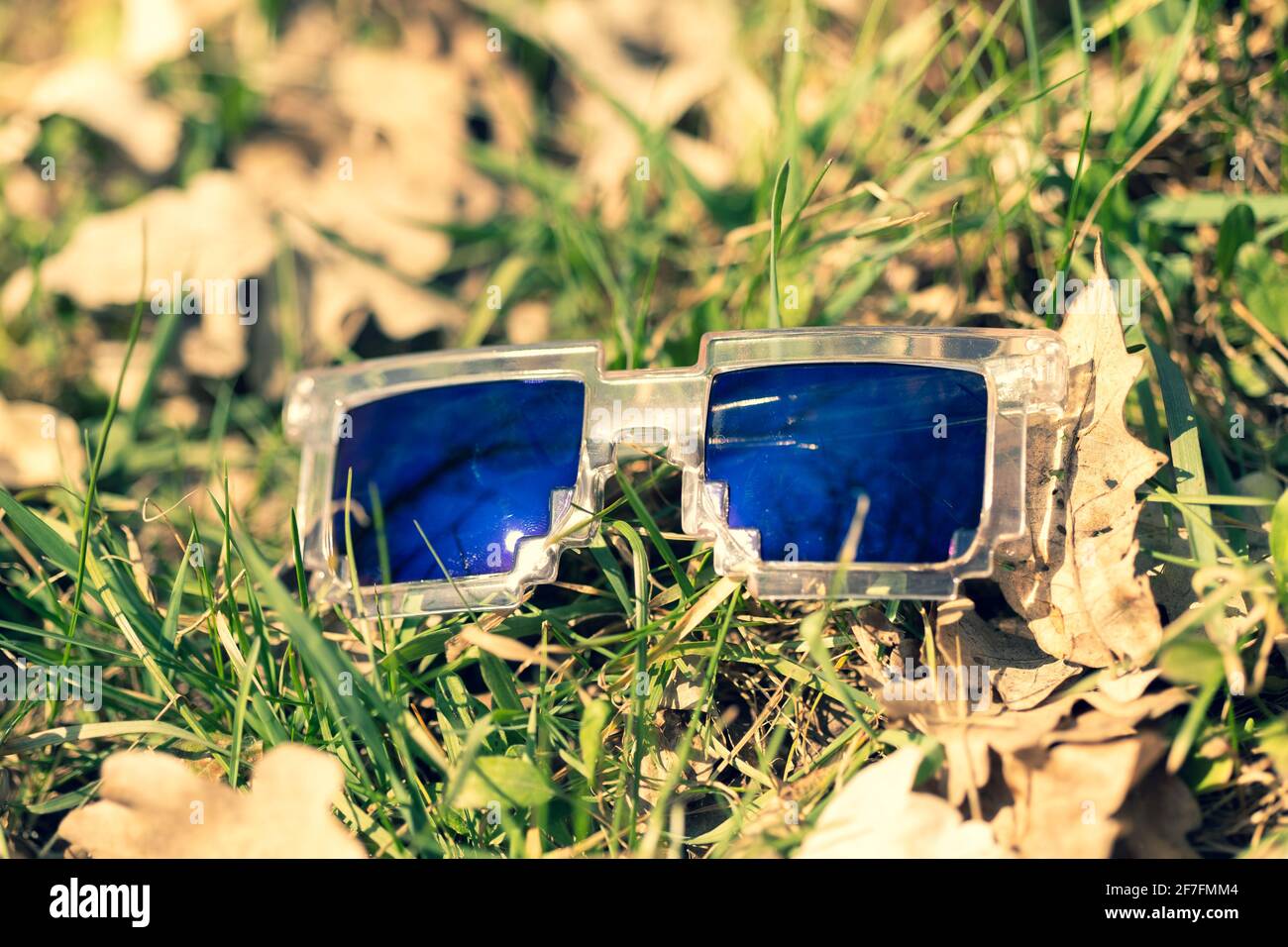 Blue lenses pixel sunglasses model shoot in a summer day closeup. Selective focus Stock Photo