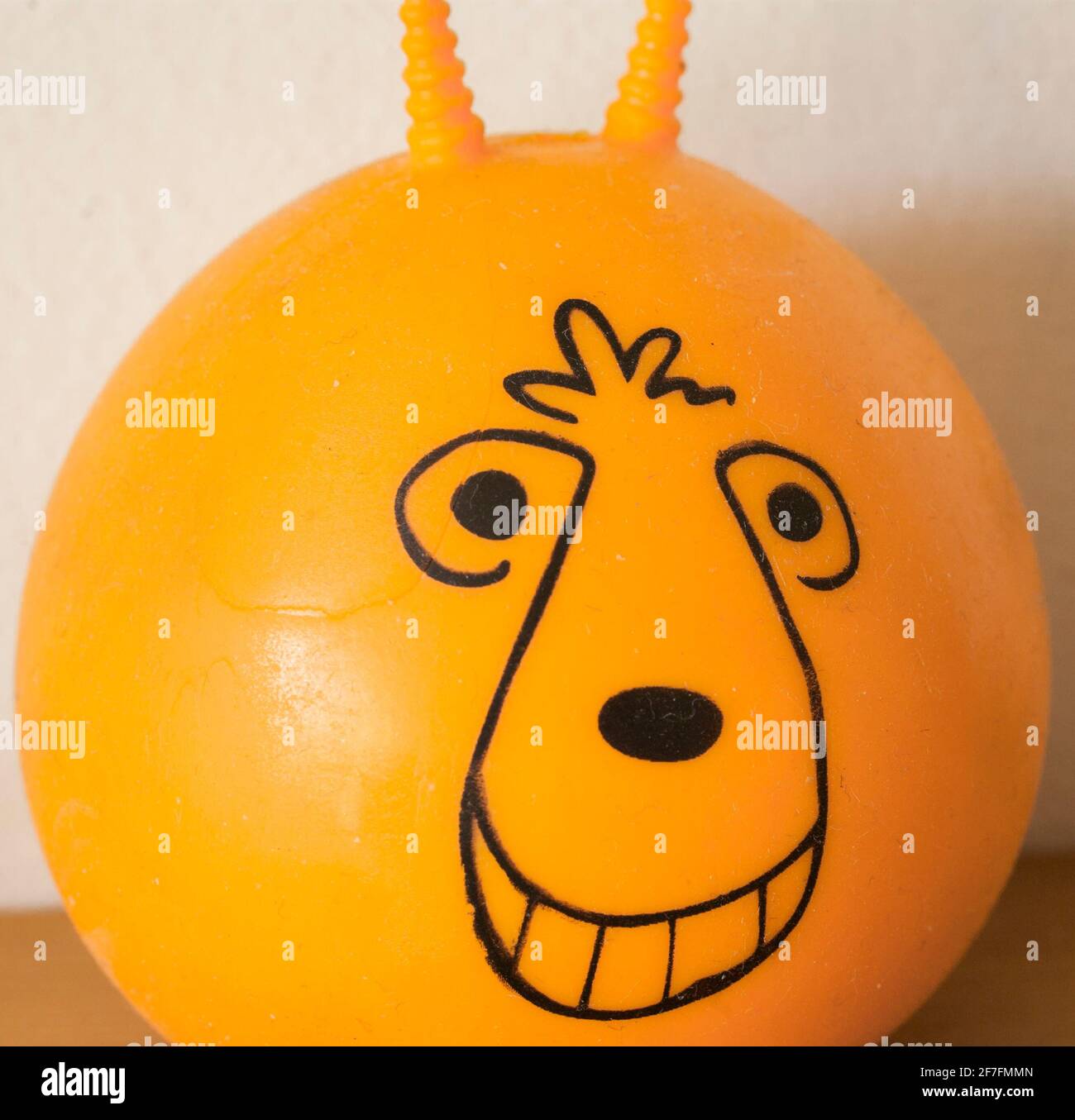 A close up of an orange stress ball in the form of a miniature space hopper. UK. Stock Photo