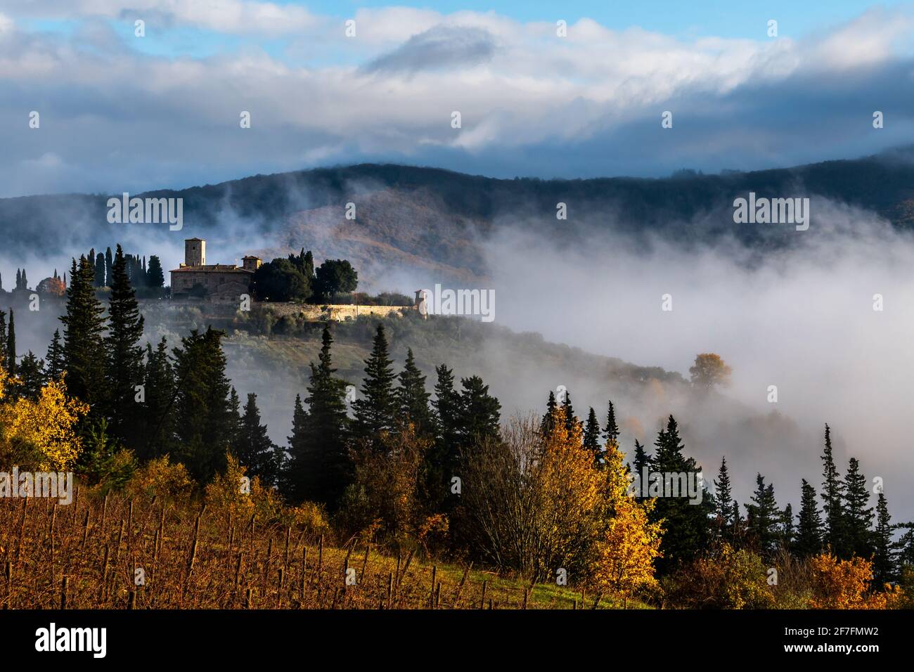 Castello di Colognole as sun breaks through early morning mist, Greve in Chianti, Tuscany, Italy, Europe Stock Photo