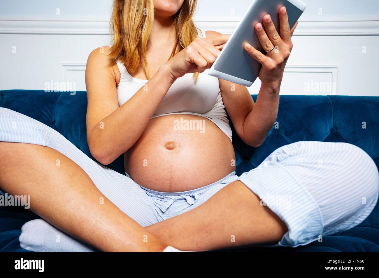Close photo of a pregnant woman touching belly Stock Photo