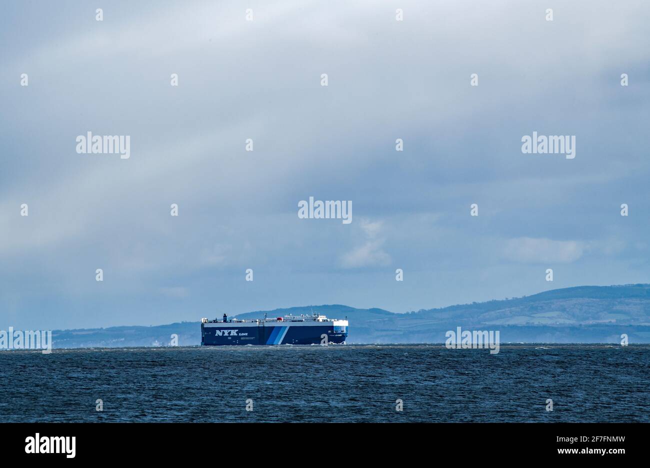 Large Container Ship leaving Avonmouth Docks and heading down the Bristol Channel with the tide Stock Photo