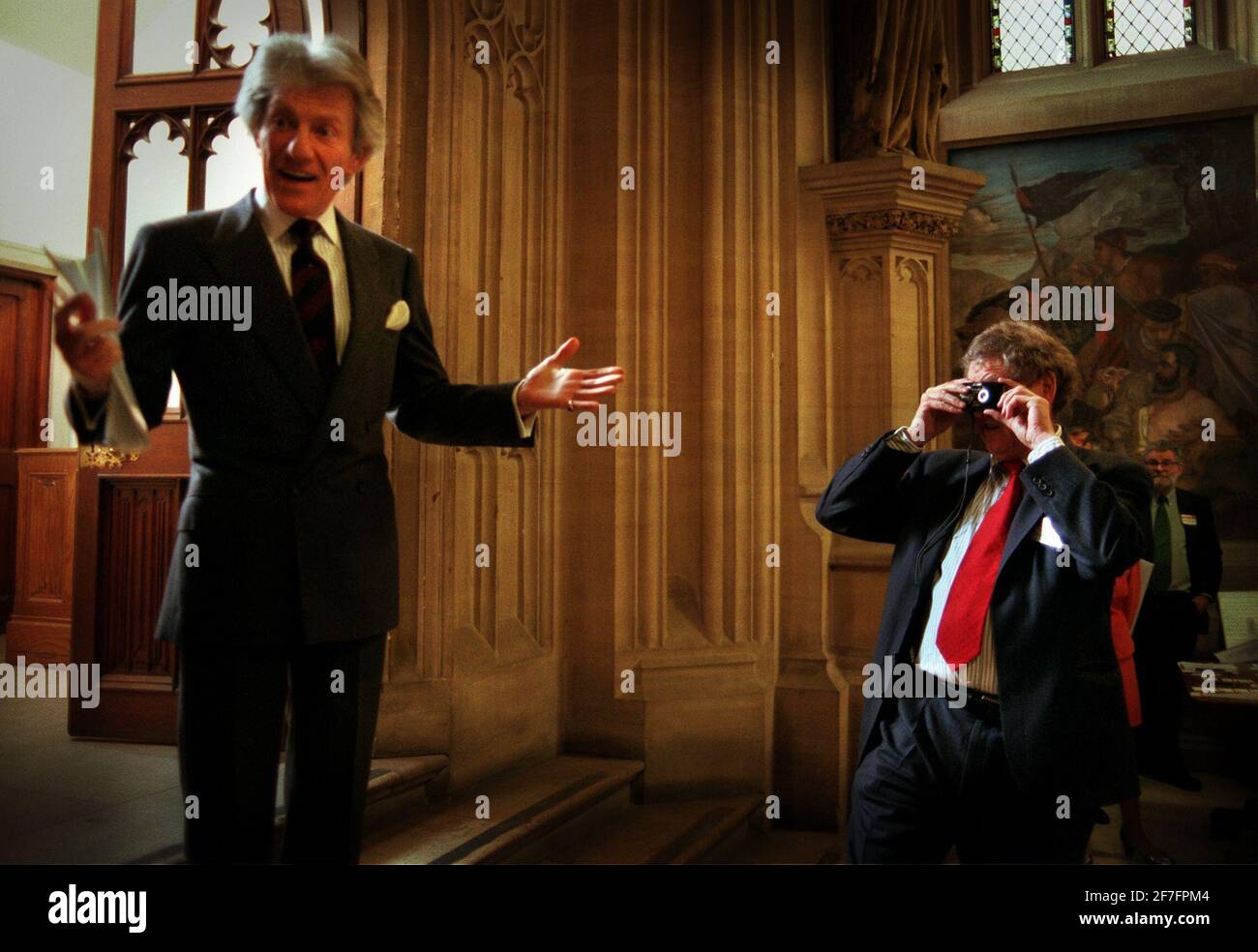 Austin Mitchell MP takes a picture of the Earl of Lichfield as he opened the Parliamentary Photographic Group's exhibition at the Commons in Westminster Stock Photo