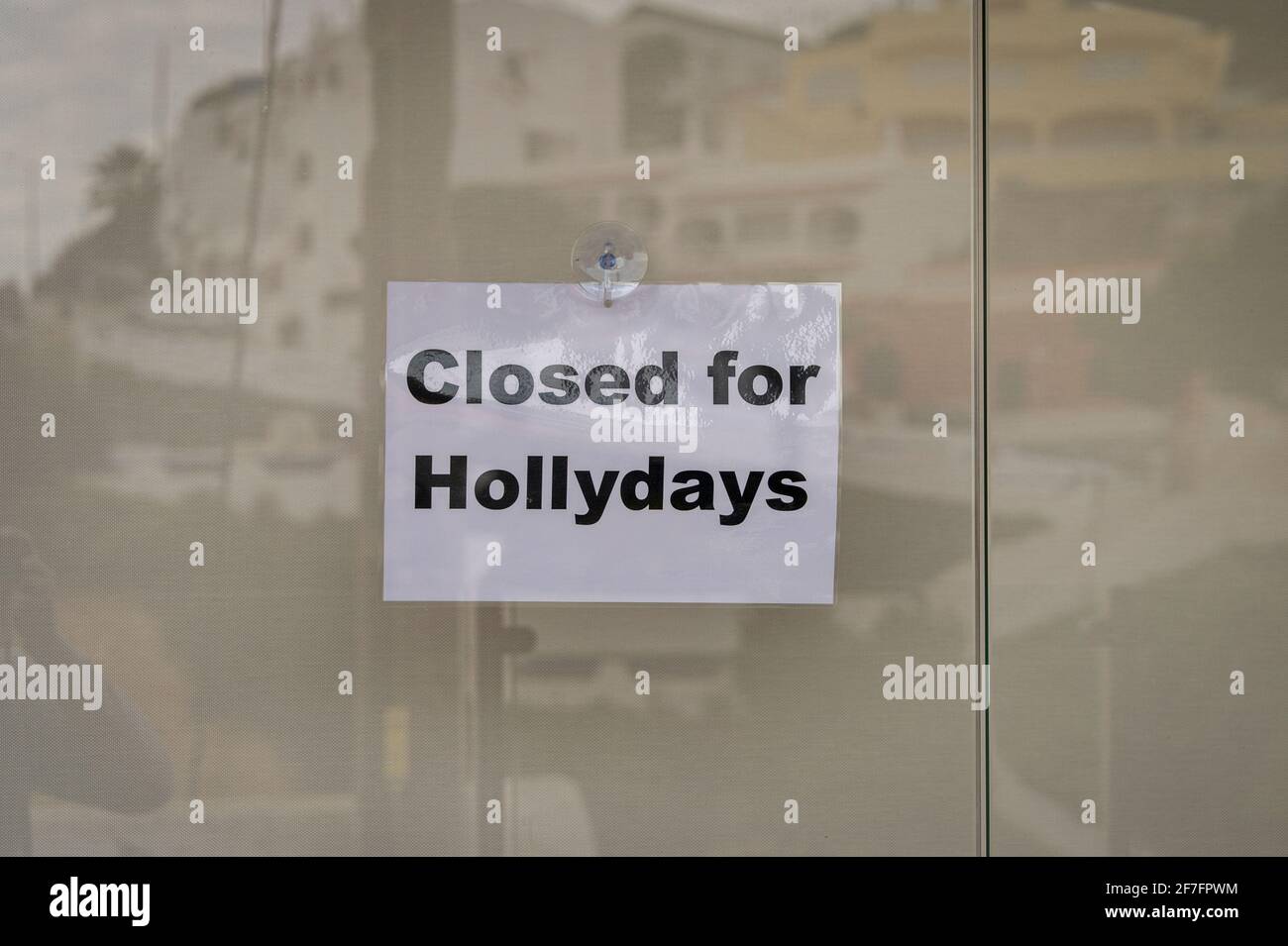 Closed for Hollydays sign in a window of a shop. Stock Photo