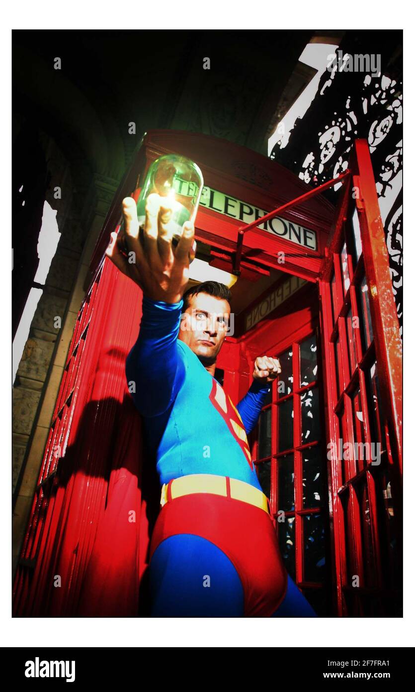 Superman flew into Piccadilly today to deliver a lump of Kryptonite to mark the 70th anniversary of his arrival on earth. Commissioned at the request of the Royal Society of Chemistry the crystal was produced by the University of Leicester, whose chemistry dept has worked on the real element Krypton. The superhero delivered the glass covered  kryptonite to Dr. Ted Nield at the Geological Society, after changing in Londons earliest telephone box under the arched entrance to Burlington house where both Learned Societies are located.pic David Sandison 31/1/2003 Stock Photo