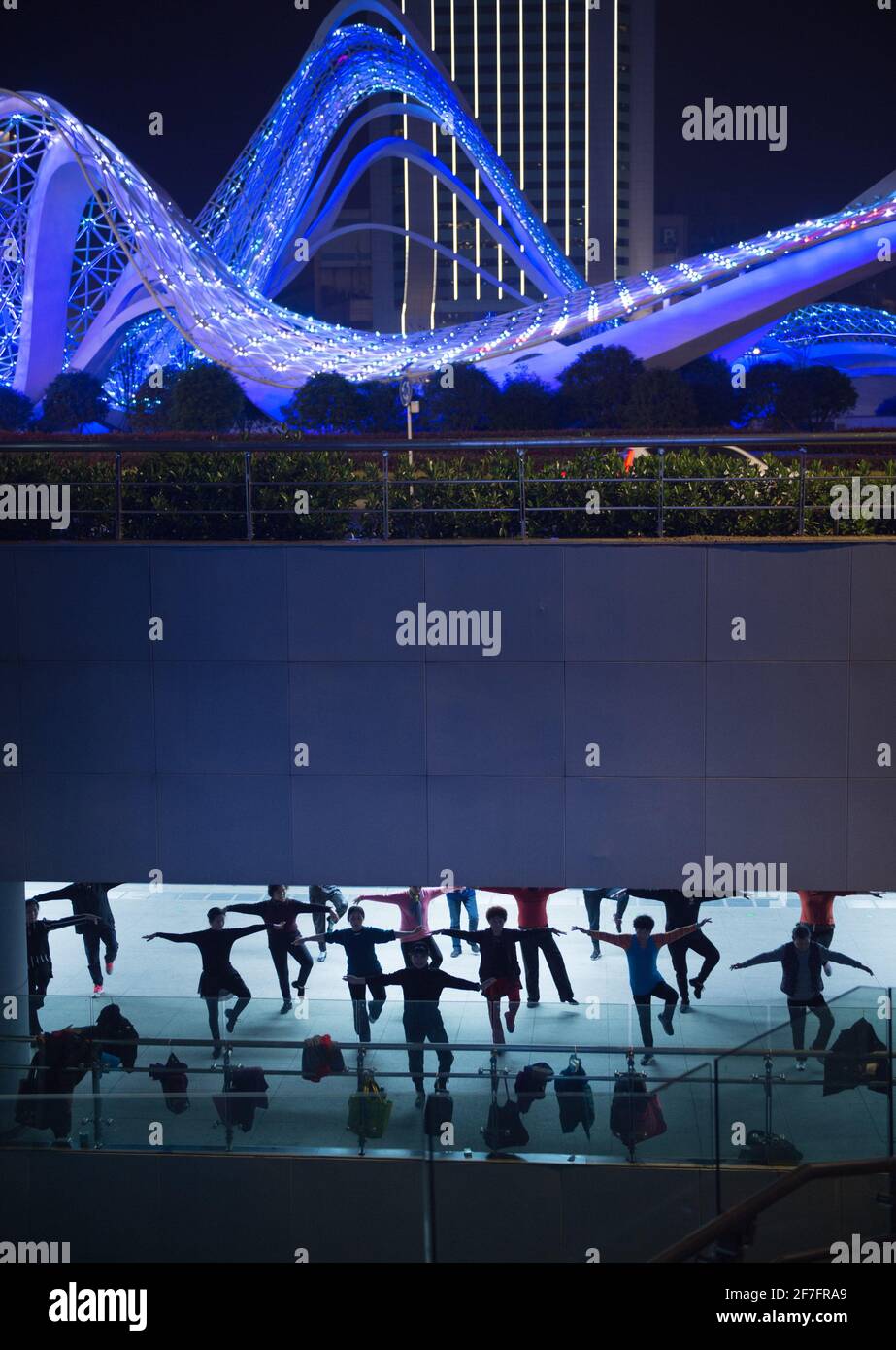 Wuhan, COVID-19. 8th Apr, 2020. People exercise at a plaza in Wuhan, central China's Hubei Province, April 2, 2021. Wuhan, once hit hard by COVID-19, has seen its urban life at night return to normal since its lockdown was lifted on April 8, 2020. Credit: Wu Zhizun/Xinhua/Alamy Live News Stock Photo