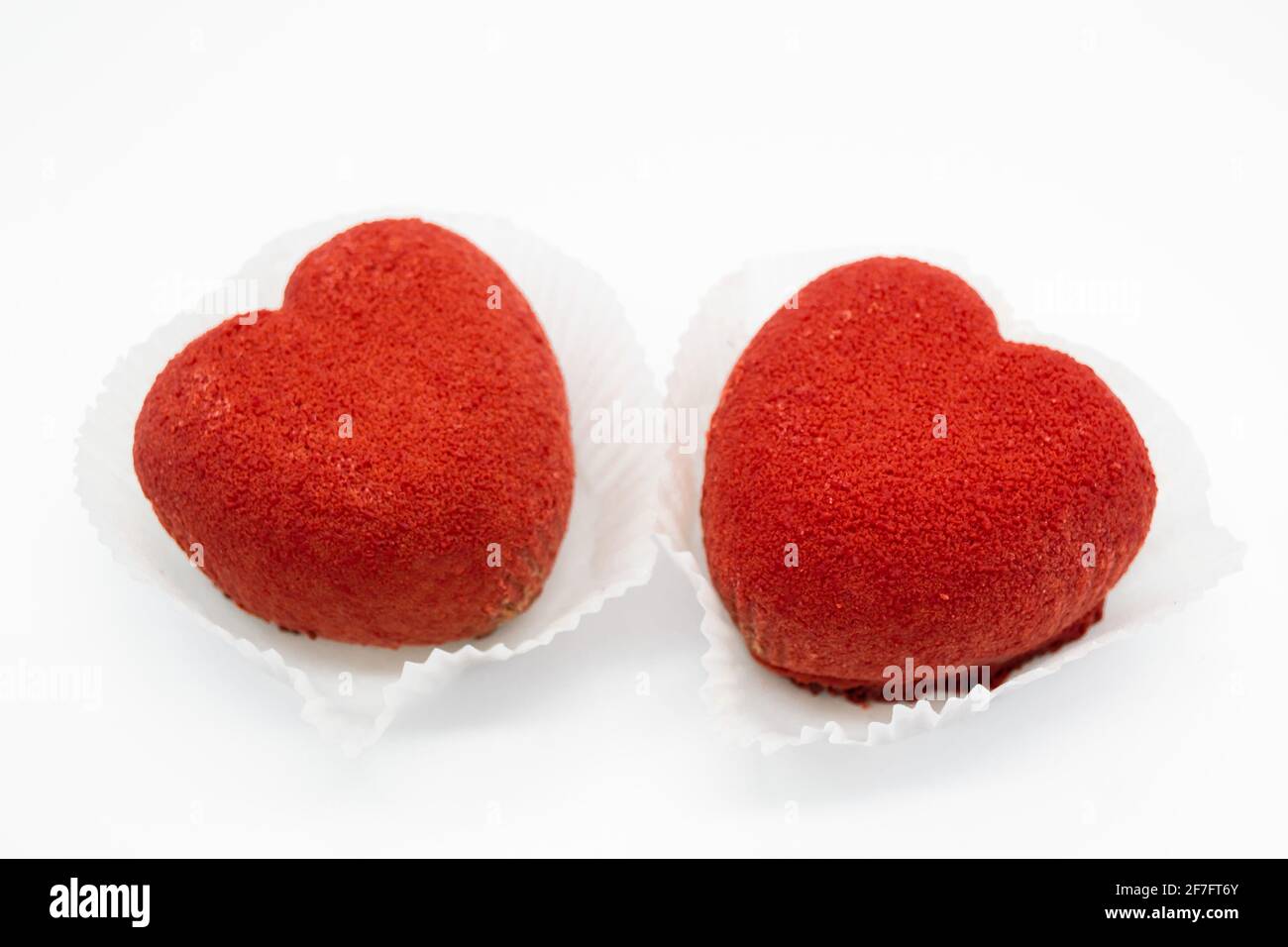 A bright red heart-shaped cakes on a white background. Copy space Stock ...
