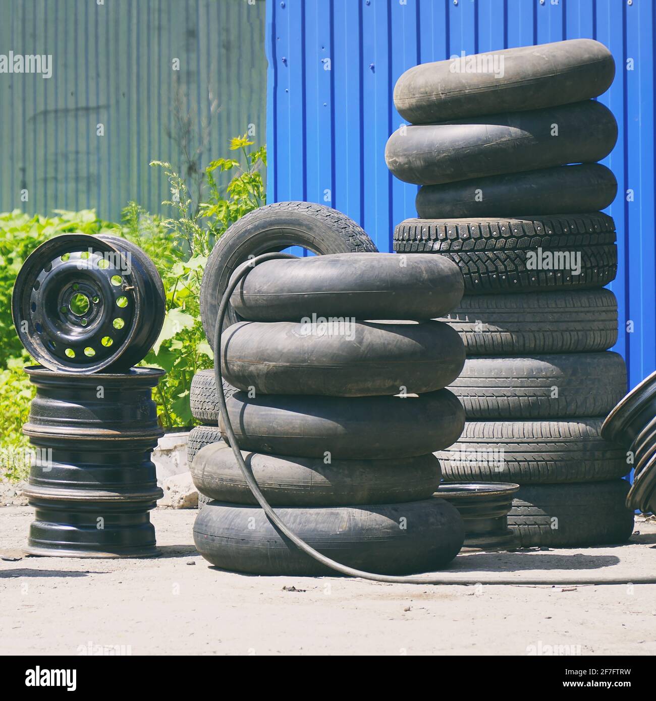 Car tires, rims and tubes or cameras next to the tire shop Stock Photo