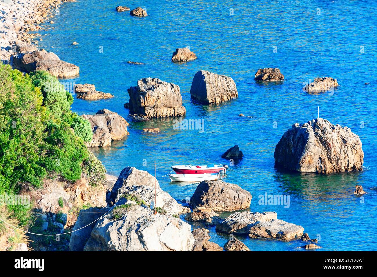 Fishing boat between rocks hi-res stock photography and images - Alamy