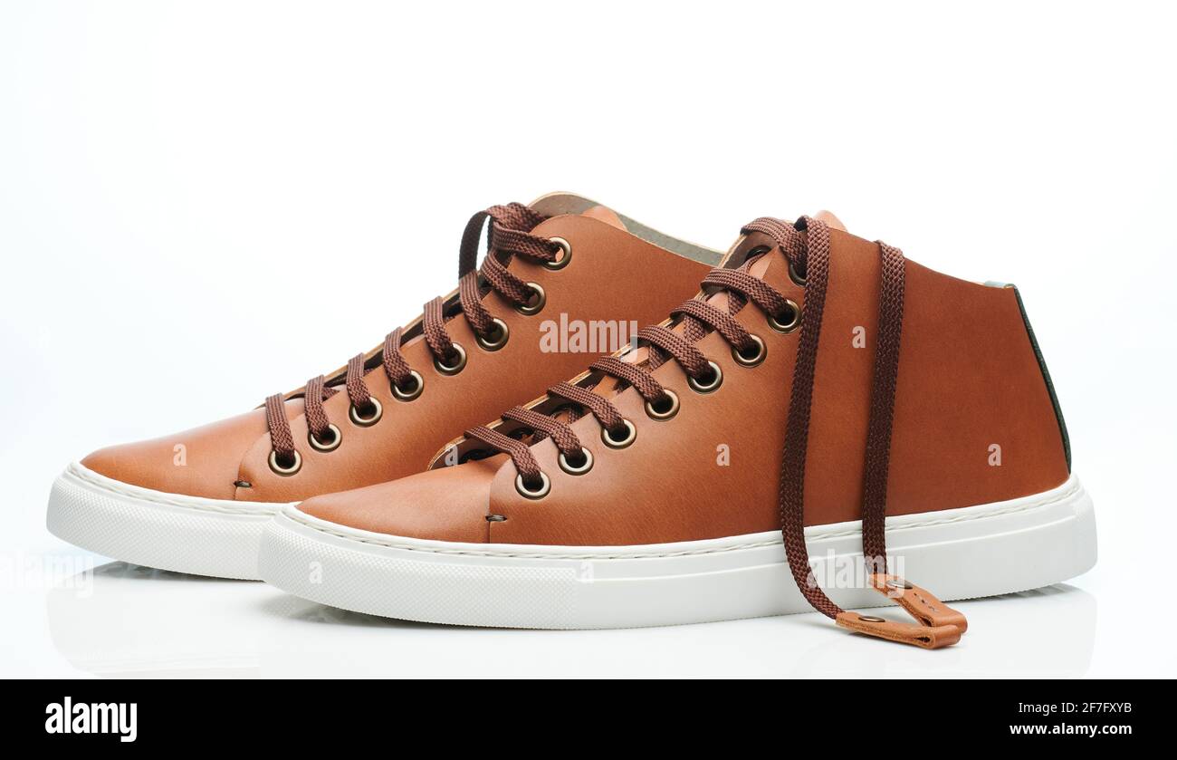 Clean brown leather pair sneakers isolated on white studio background Stock Photo
