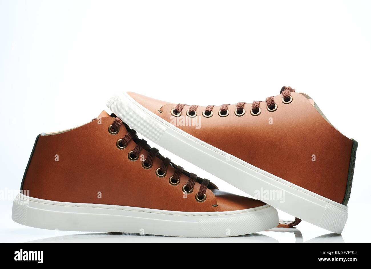 Pair of new brown sneaker shoes isolated on white studio background Stock Photo