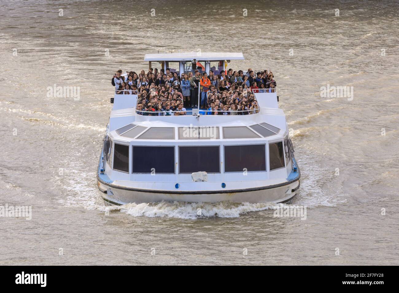 Tourists on a Thames river cruise boat in London, England, UK Stock Photo