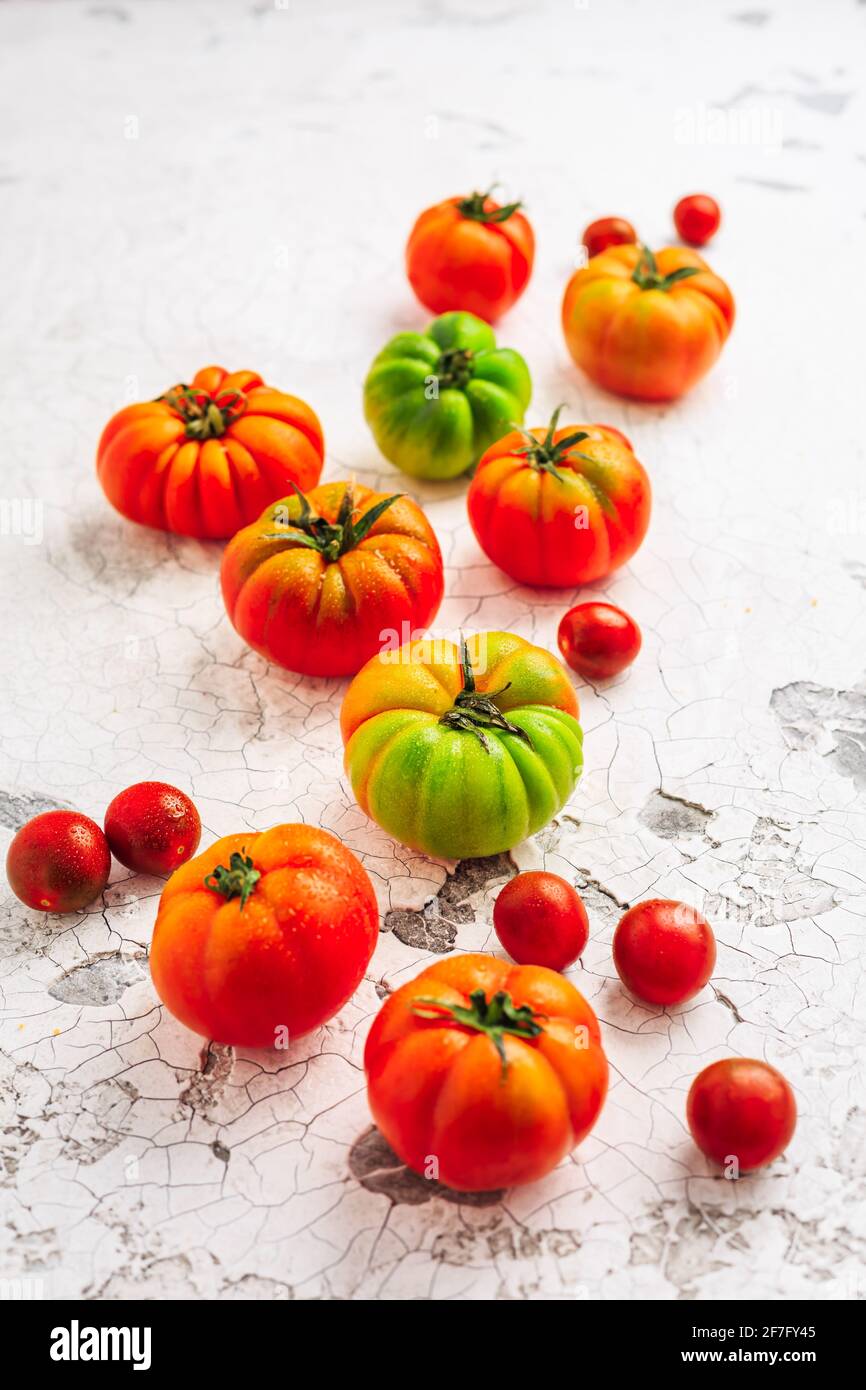 Assortment of organic tomatoes on old kitchen table Stock Photo - Alamy
