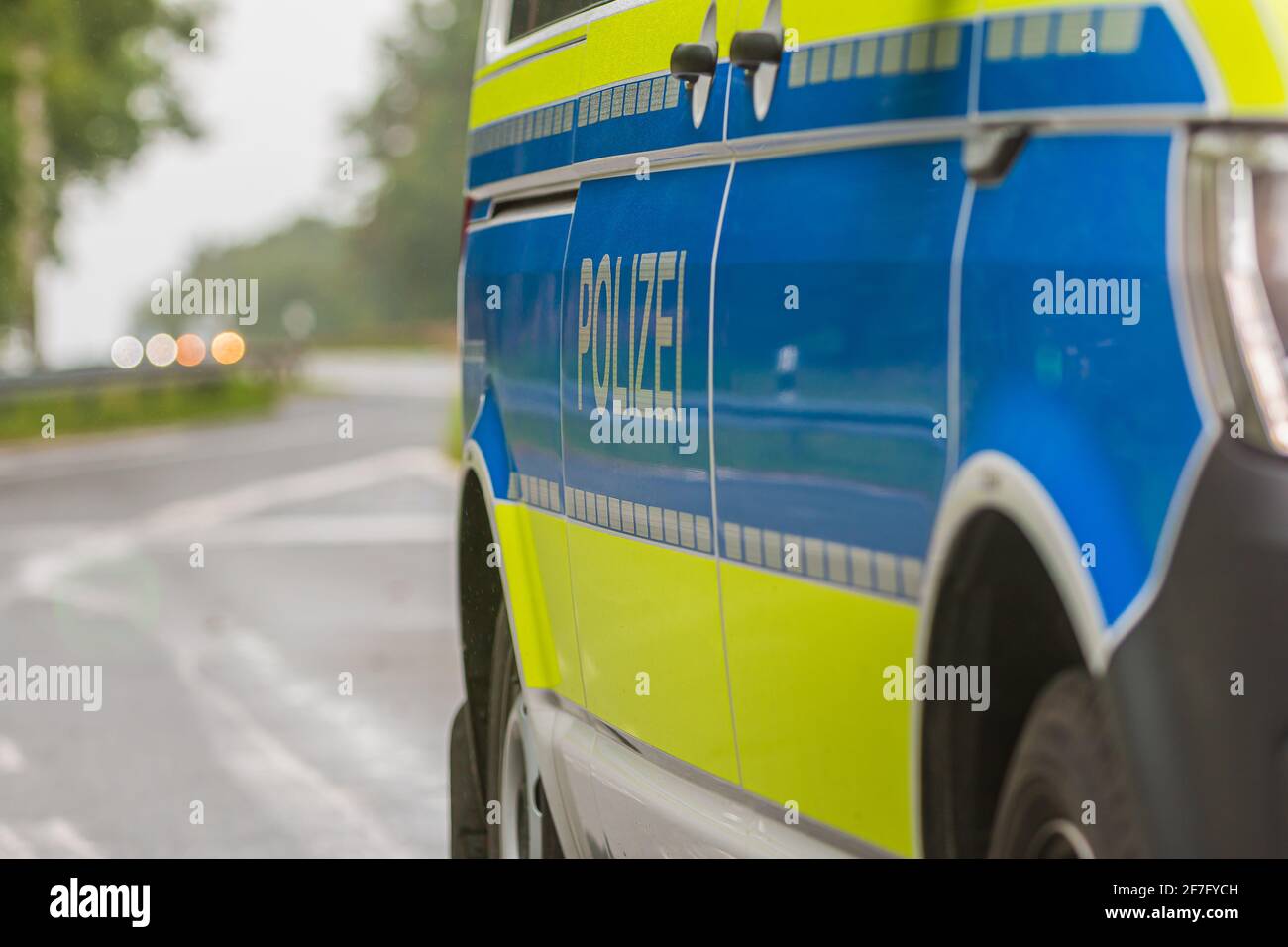 Emergency stop on the motorway with an asphalt road. Passenger side of a German police car. Police lettering on the body from the passenger side. Blue Stock Photo