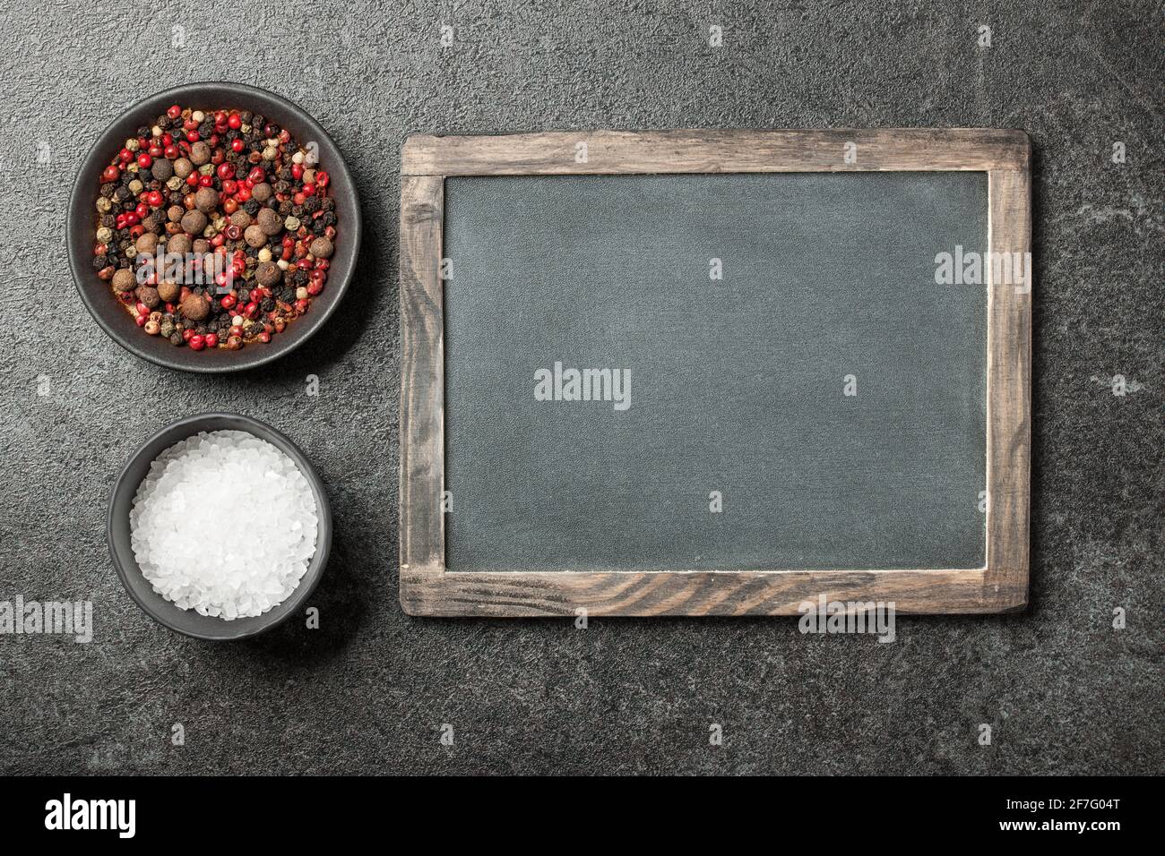 Salt and peppers in bowls Stock Photo
