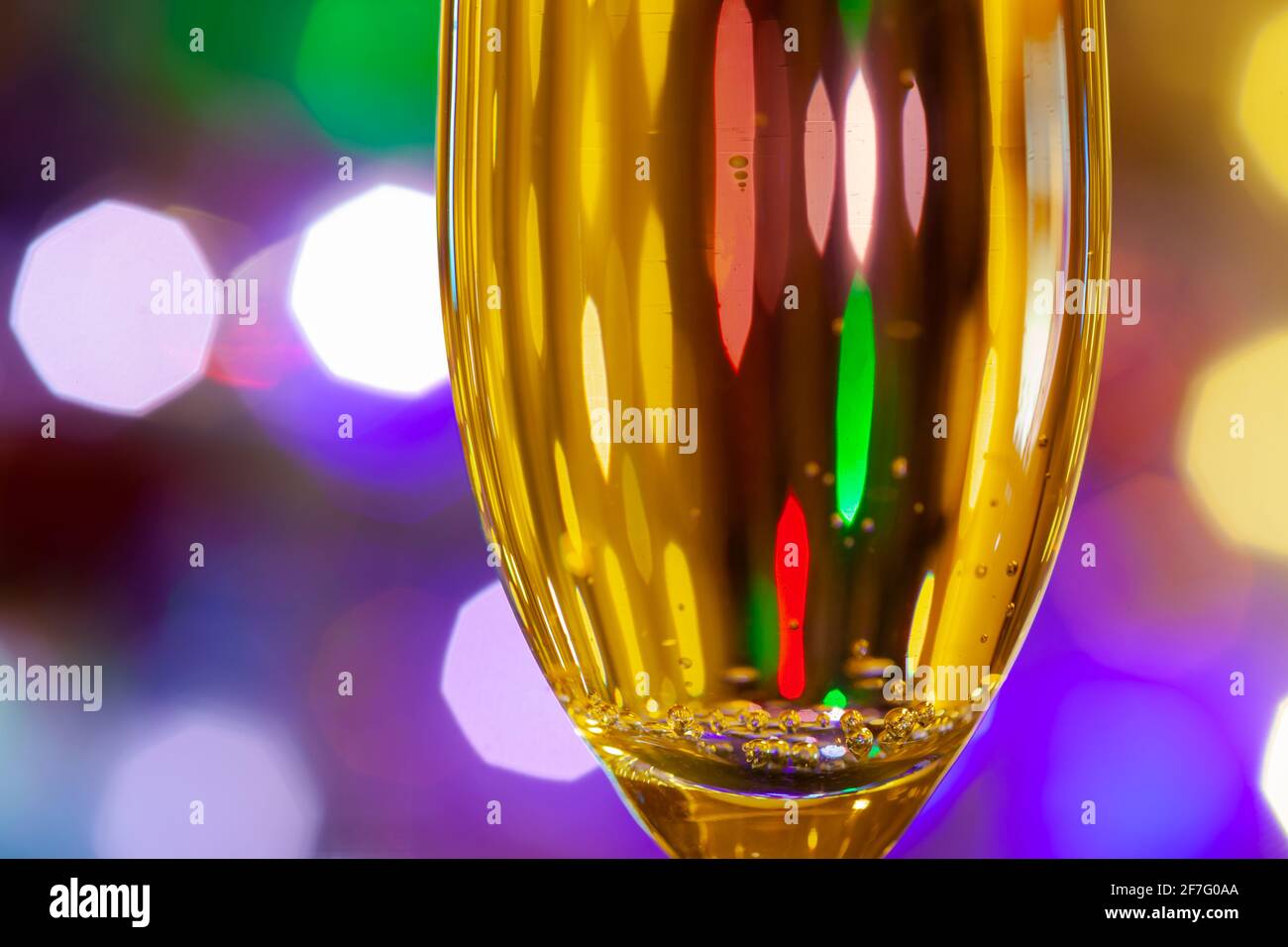 glass of champagne close-up against the background of the New Year's garland with blurry background, used as a background or texture, soft focus Stock Photo