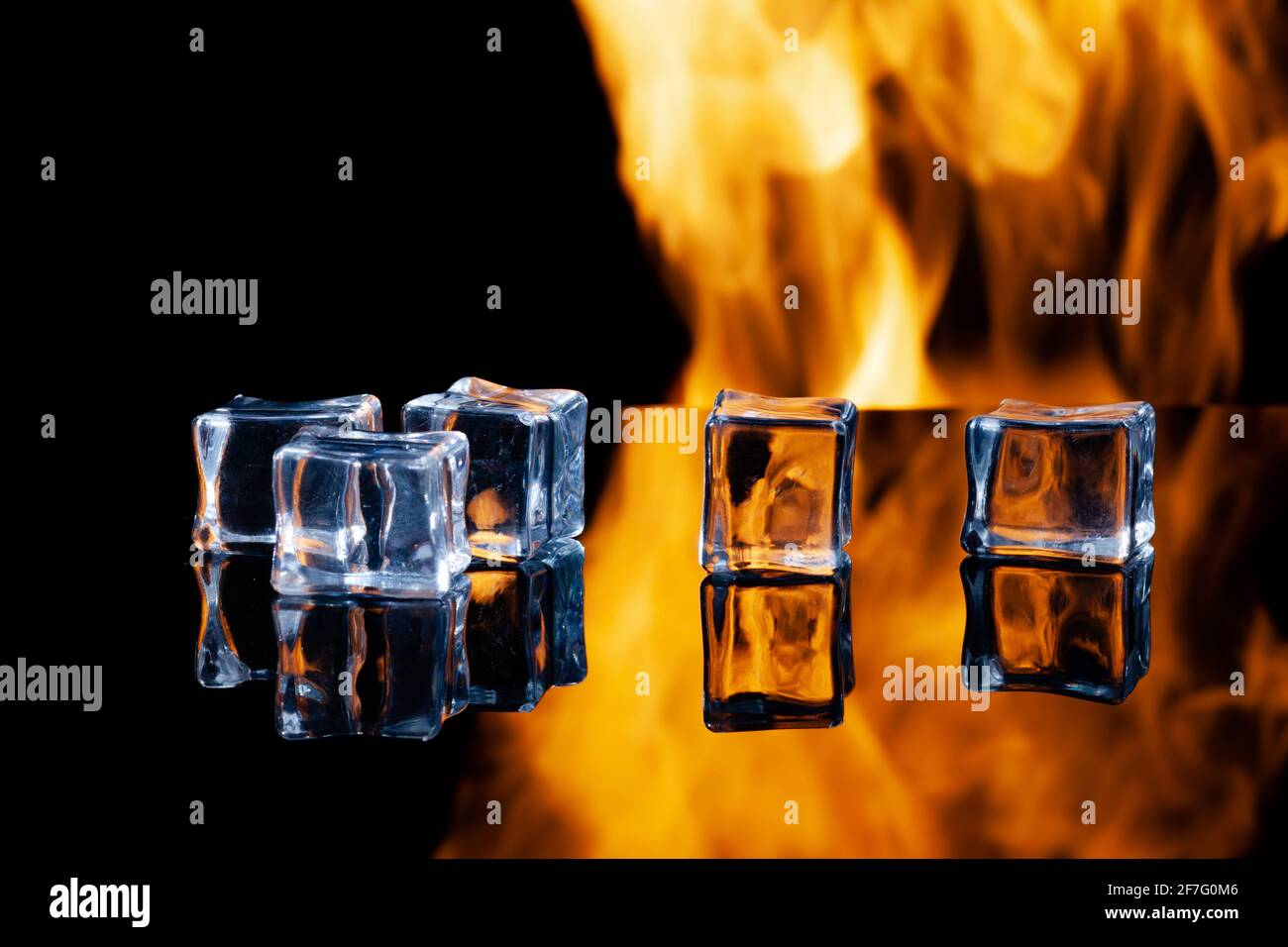 ice cubes on a black background in flames Stock Photo