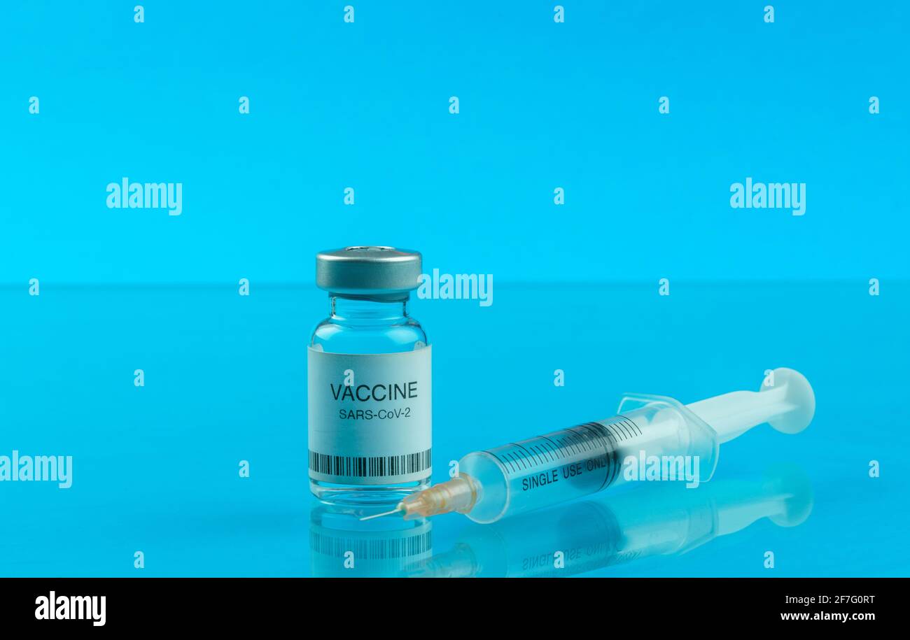 Coronavirus vaccine vial and medical syringe Stock Photo