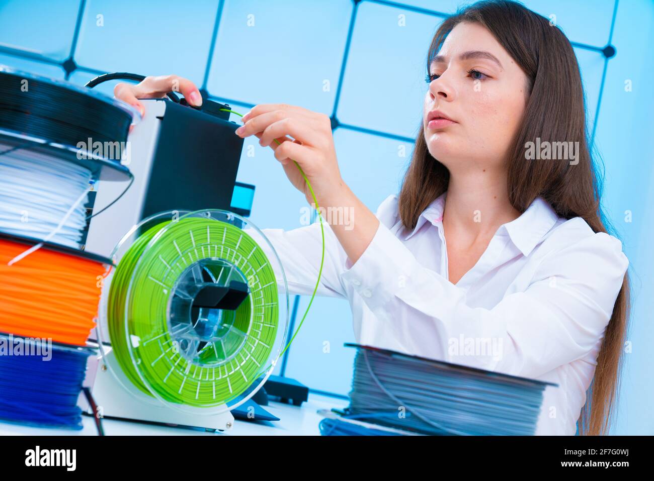 Young woman use 3d printer at office High quality photo Stock Photo