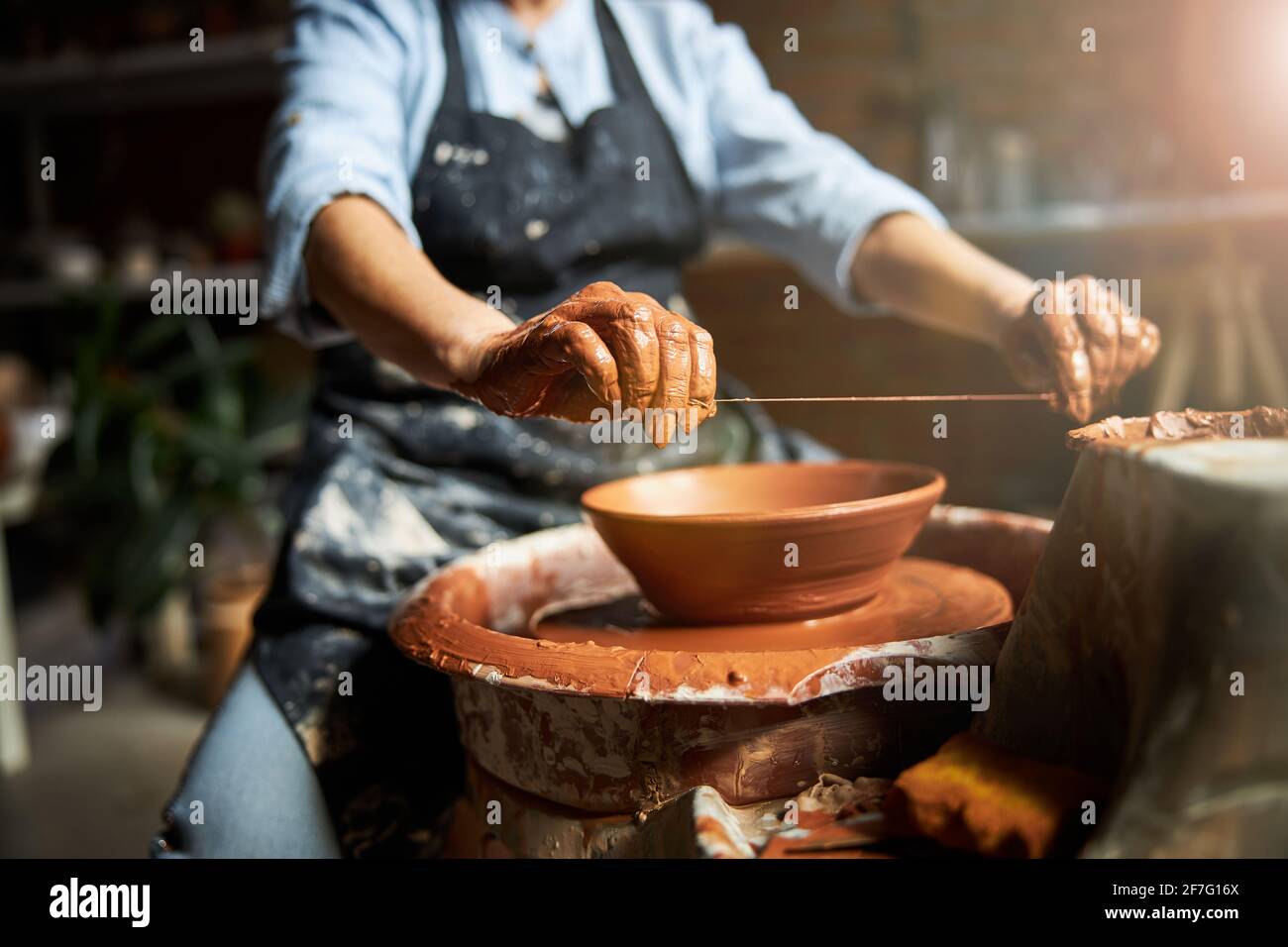 Female ceramic artist making clay bowl in pottery workshop Stock Photo ...