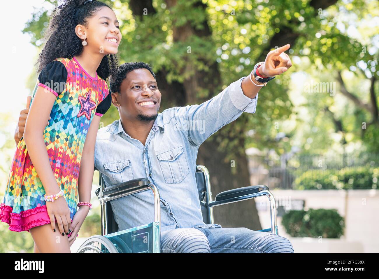 Man in a wheelchair enjoying a walk with his daughter Stock Photo - Alamy