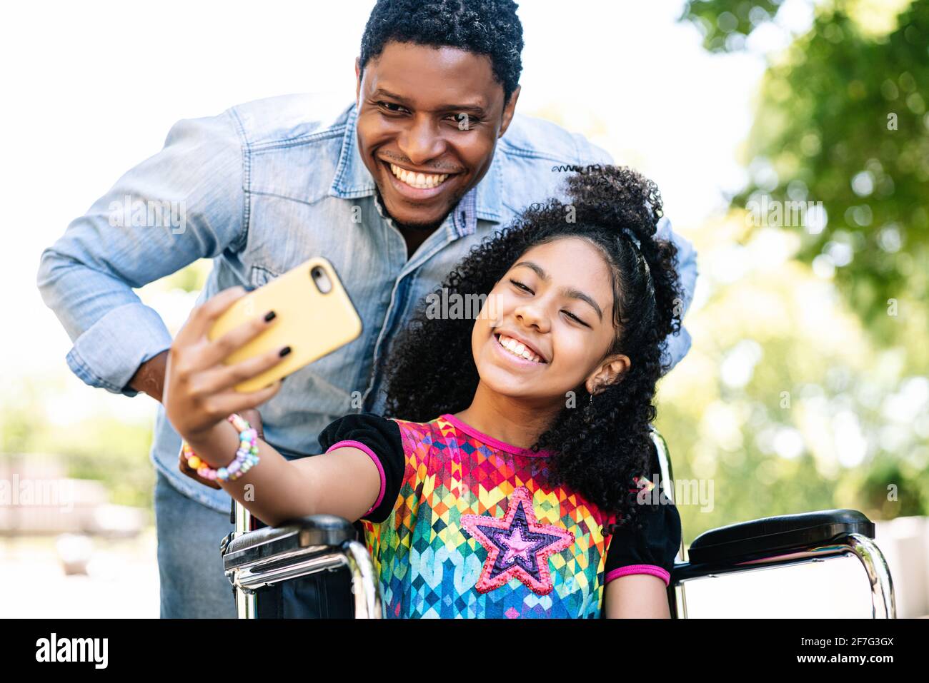 Girl in a wheelchair and her father taking a selfie with phone Stock ...