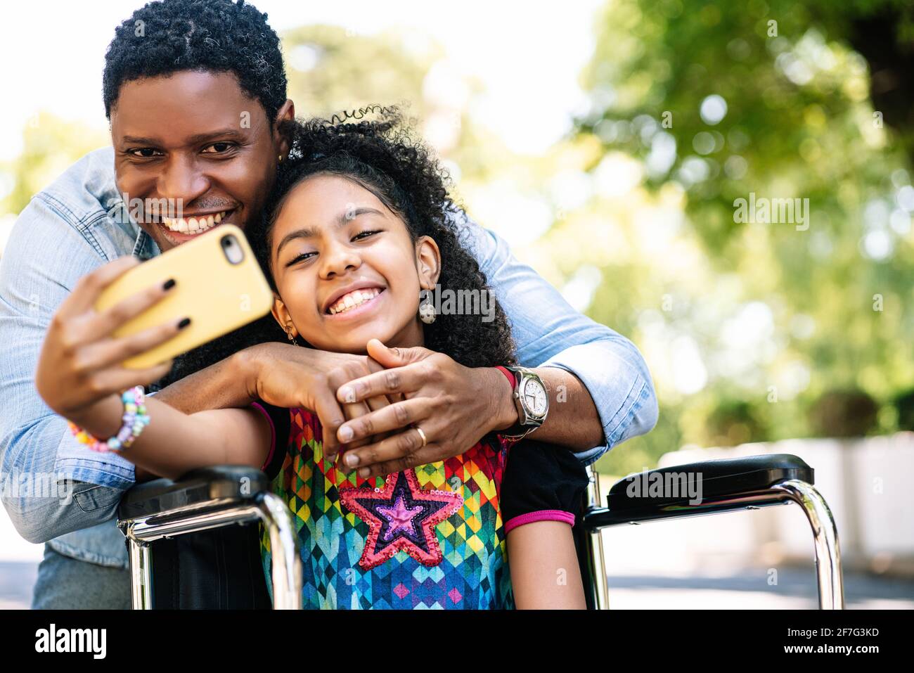 Girl in a wheelchair and her father taking a selfie with phone Stock ...