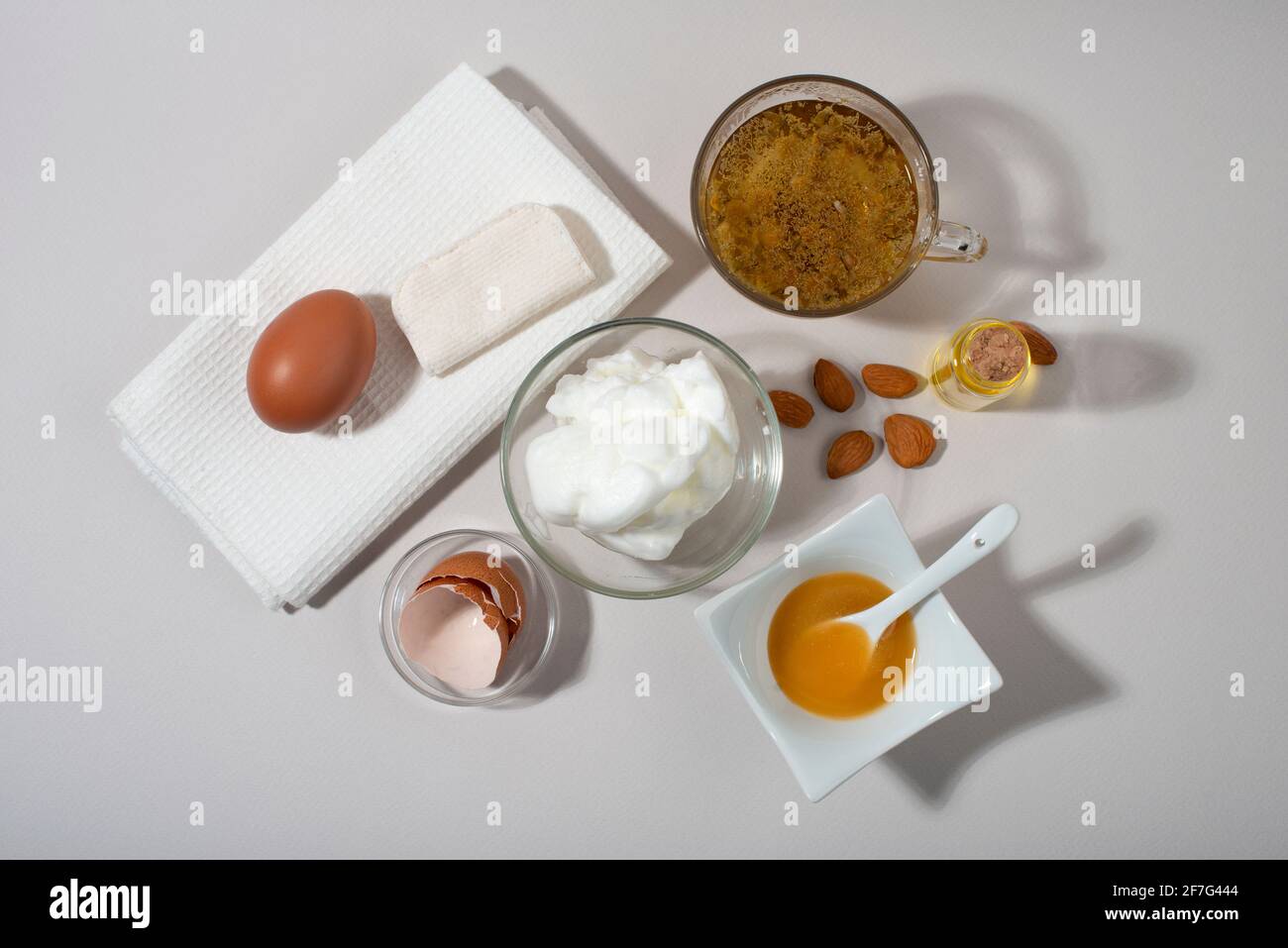 Egg White Face Mask ingredients. Whipped egg white, almond oil, honey,  chamomile tea. Homemade cosmetic. Top view Stock Photo - Alamy