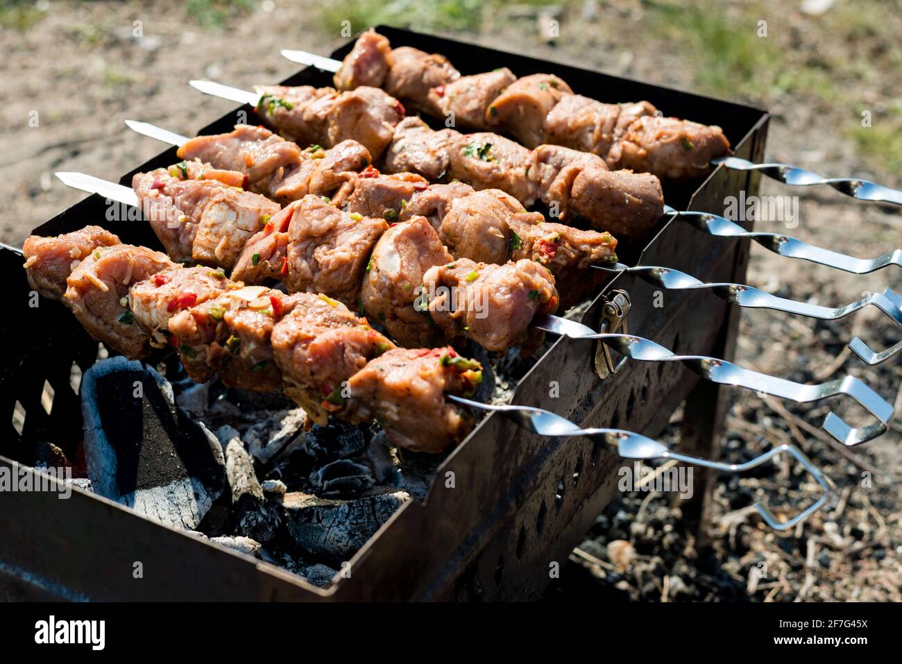Raw shish kebab on skewers, outdoor meal. Close-up Stock Photo