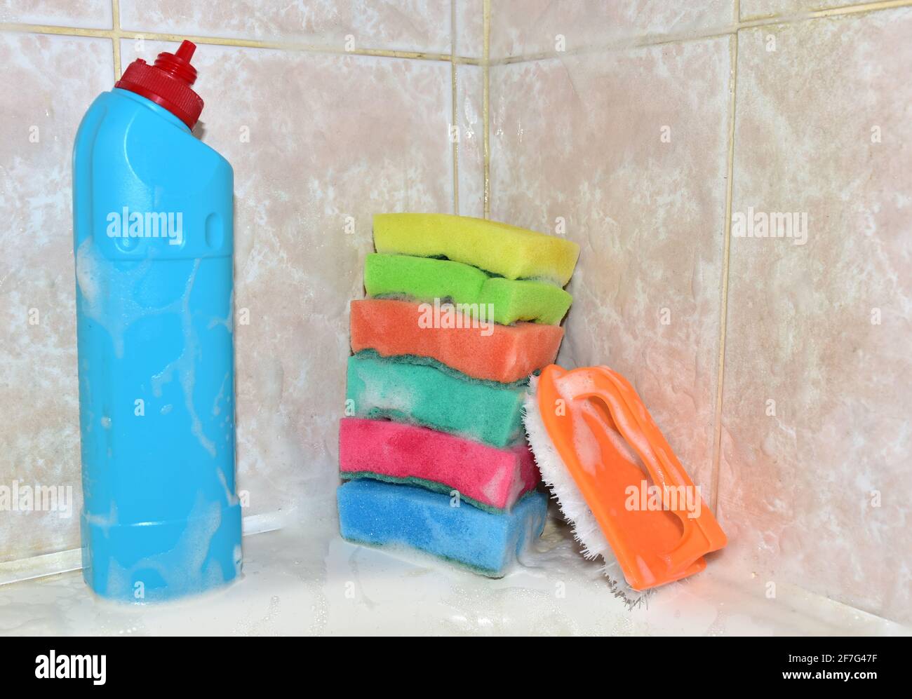 Detergent bottle and sponge during cleaning bathroom or toilet