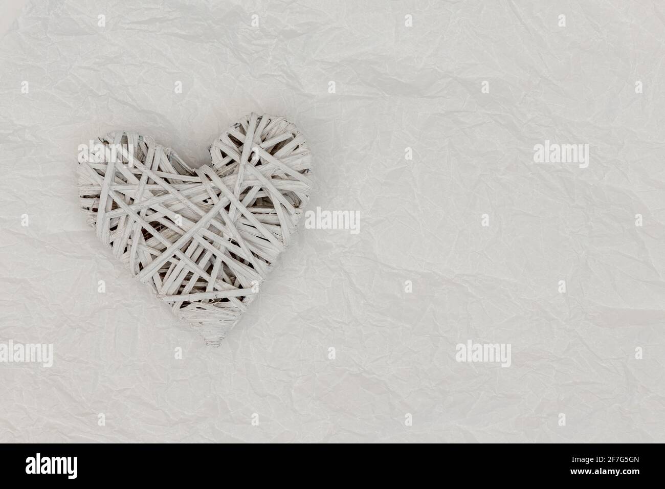 Love and still life concept. Valentines day holiday card with heart. Wood heart made of interwoven natural twigs symbolic of love and romance. Stock Photo