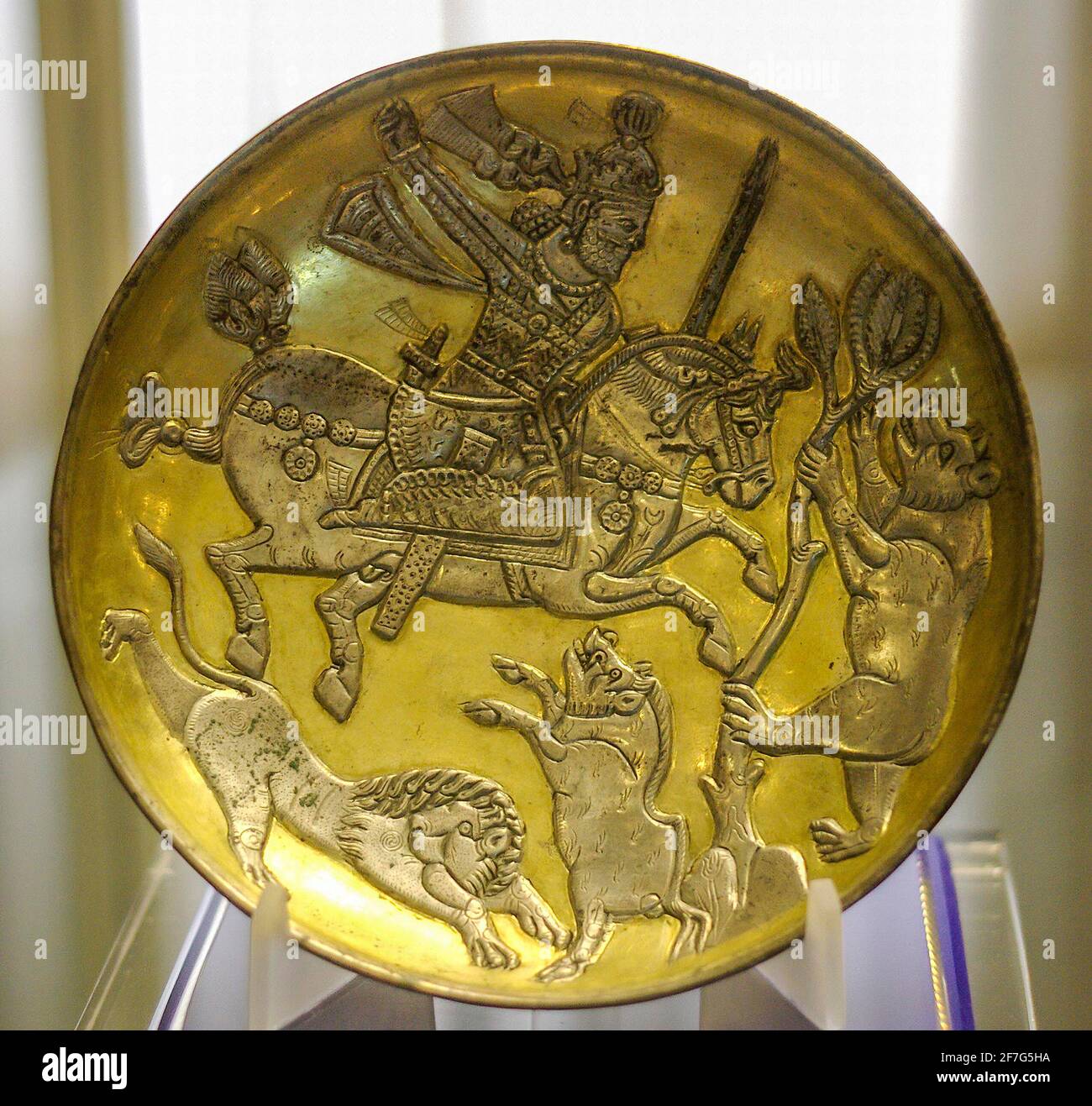 Sasanian gold-plated silver dish depicting the King hunting a lion, a boar and a bear, Tabriz Museum, Iran. Stock Photo