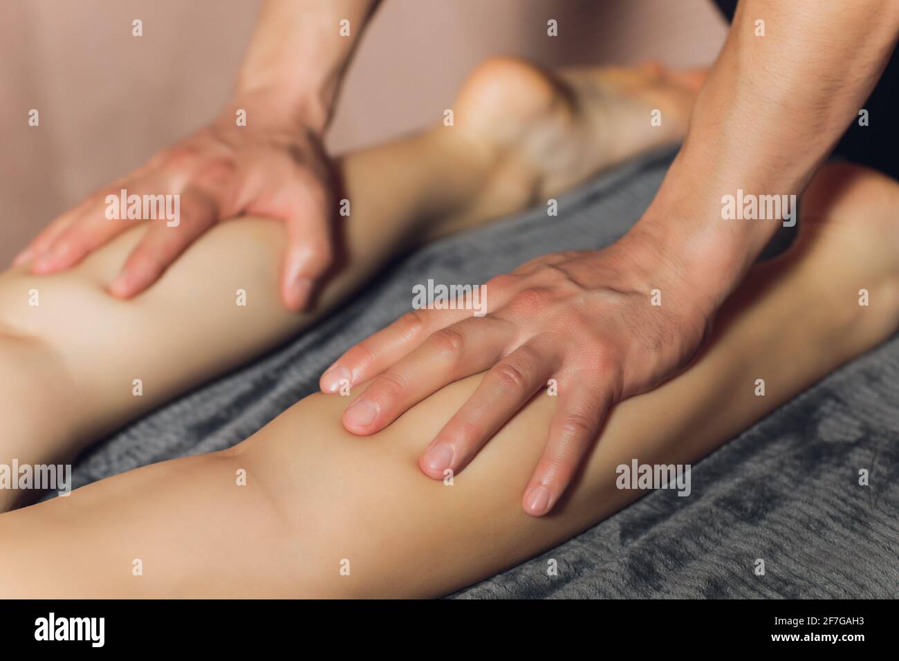 A foot massage being carried out in a spa by a masseuse Stock Photo