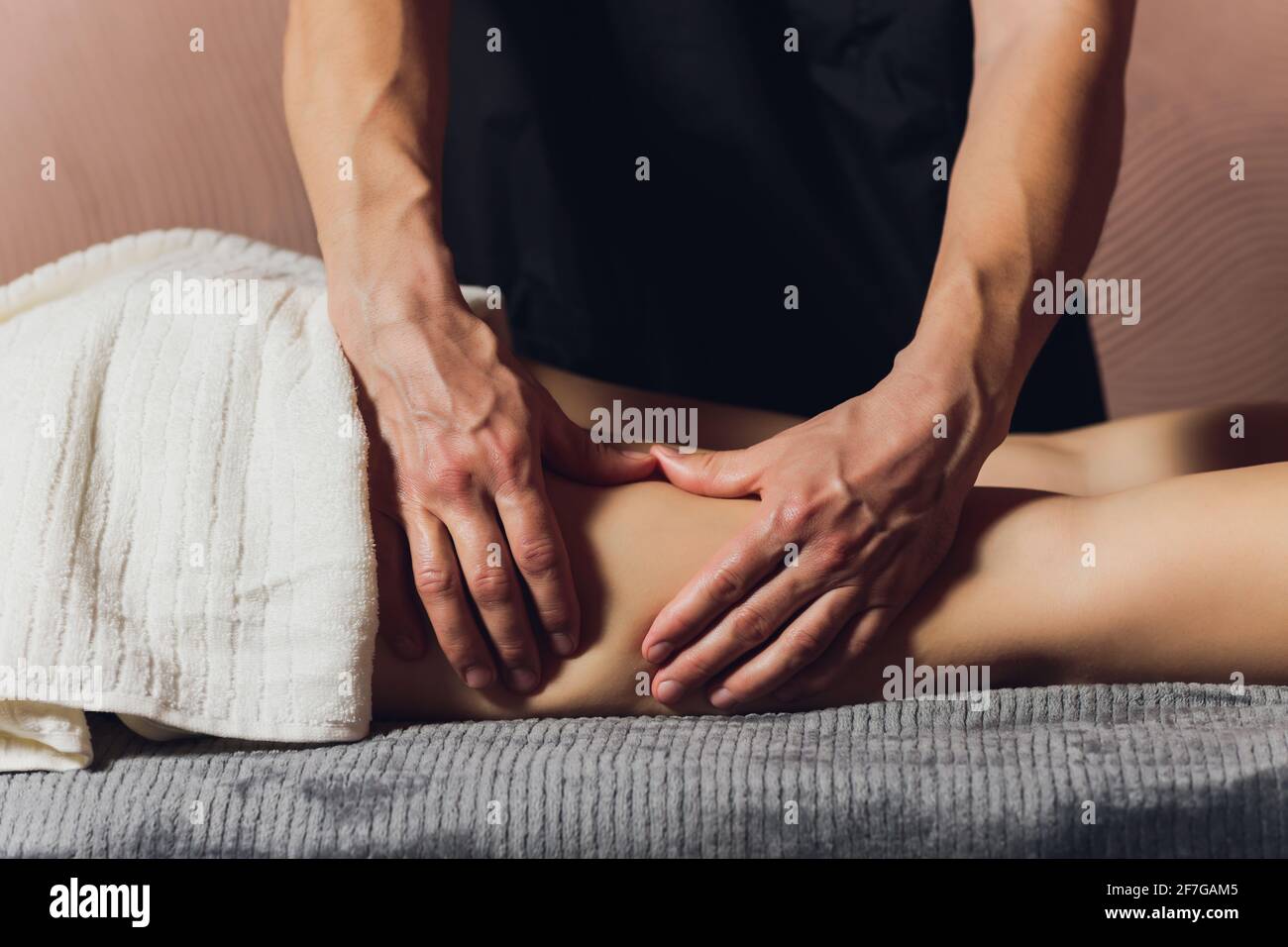 A foot massage being carried out in a spa by a masseuse Stock Photo