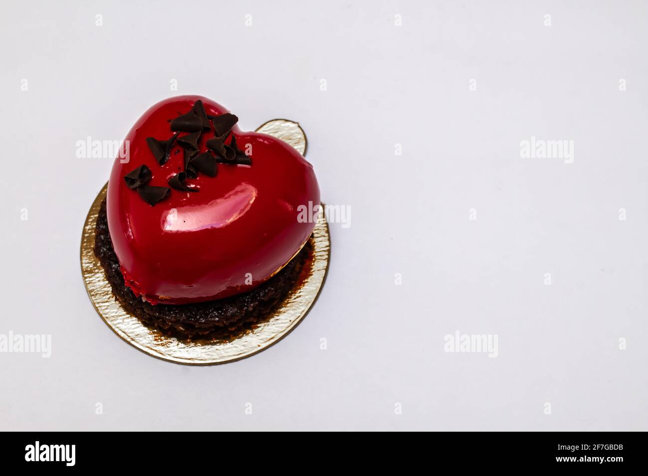 A heart-shaped, cherry-red champagne and berry chocolate miniature cake made for Valentine's Day 2021, Ontario, Canada. Stock Photo
