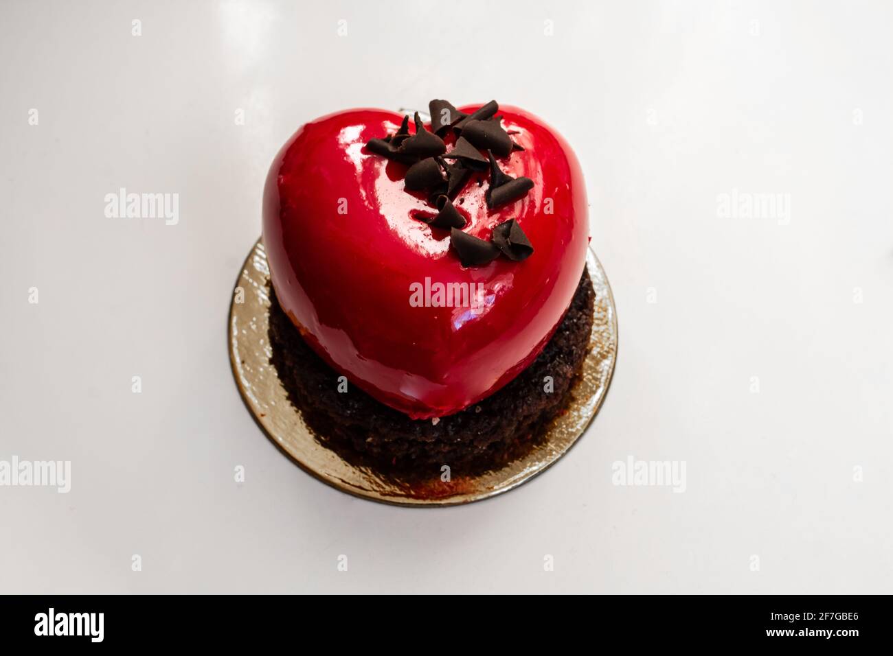 A heart-shaped, cherry-red champagne and berry chocolate miniature cake made for Valentine's Day 2021, Ontario, Canada. Stock Photo