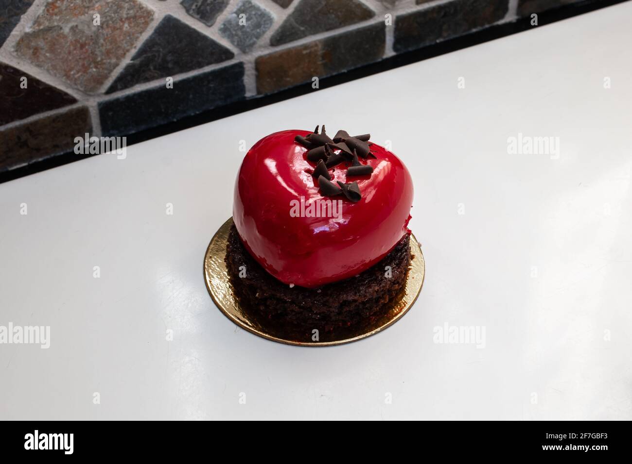 A heart-shaped, cherry-red champagne and berry chocolate miniature cake made for Valentine's Day 2021, Ontario, Canada. Stock Photo