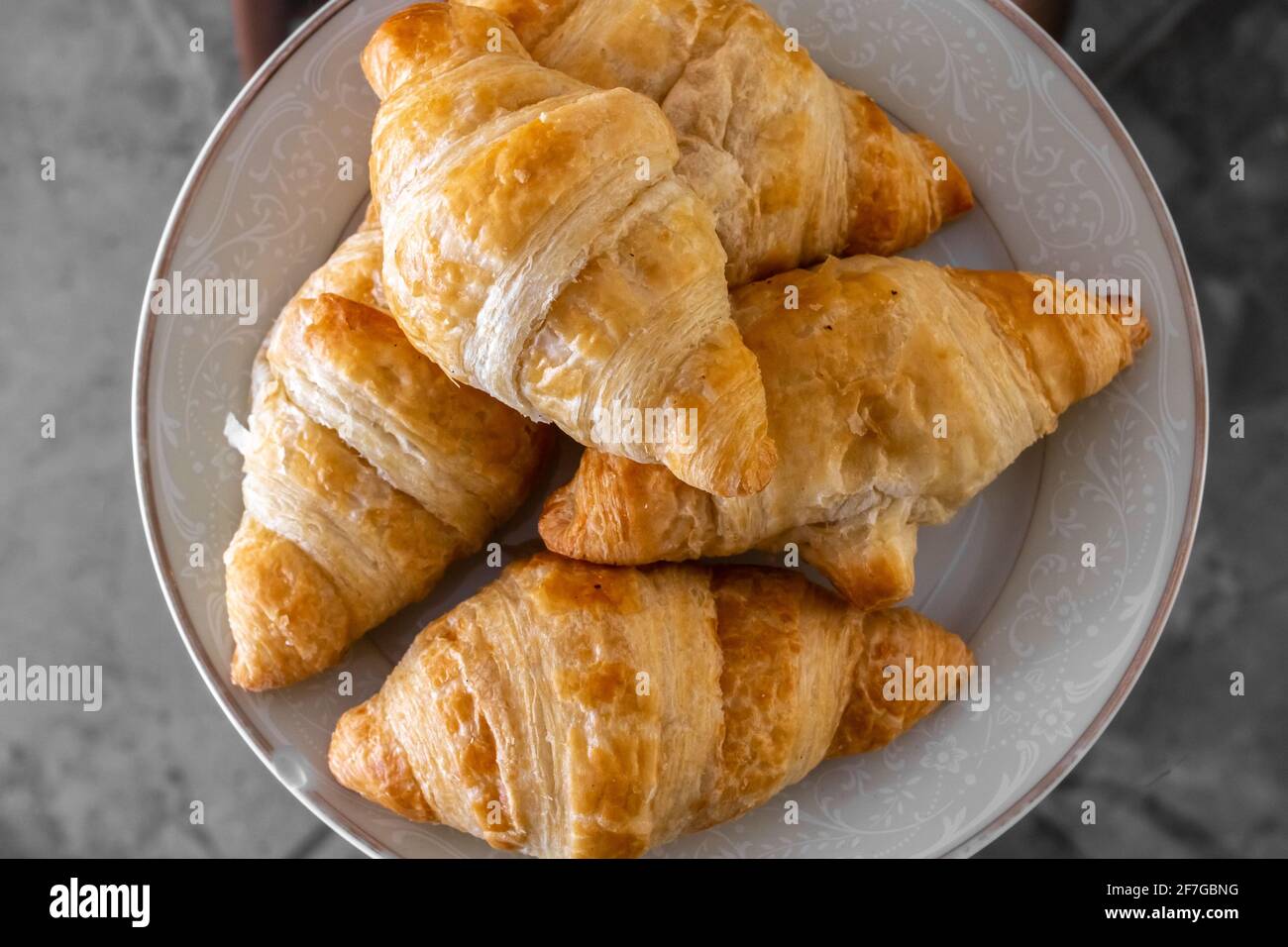 A plate of delicious golden, warm miniature croissants, photographed up close, in Toronto, Ontario, Canada, February 2021. Stock Photo
