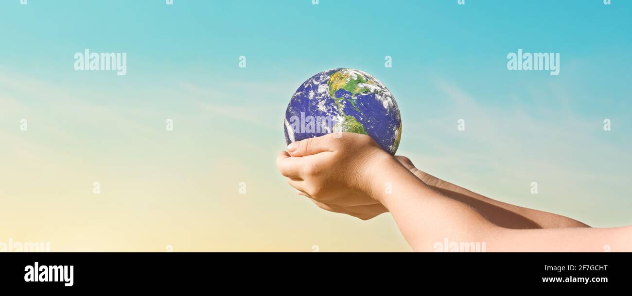 Environment day concept, Globe in hands over blue sky background. Save of earth. Elements of this image furnished by NASA Stock Photo