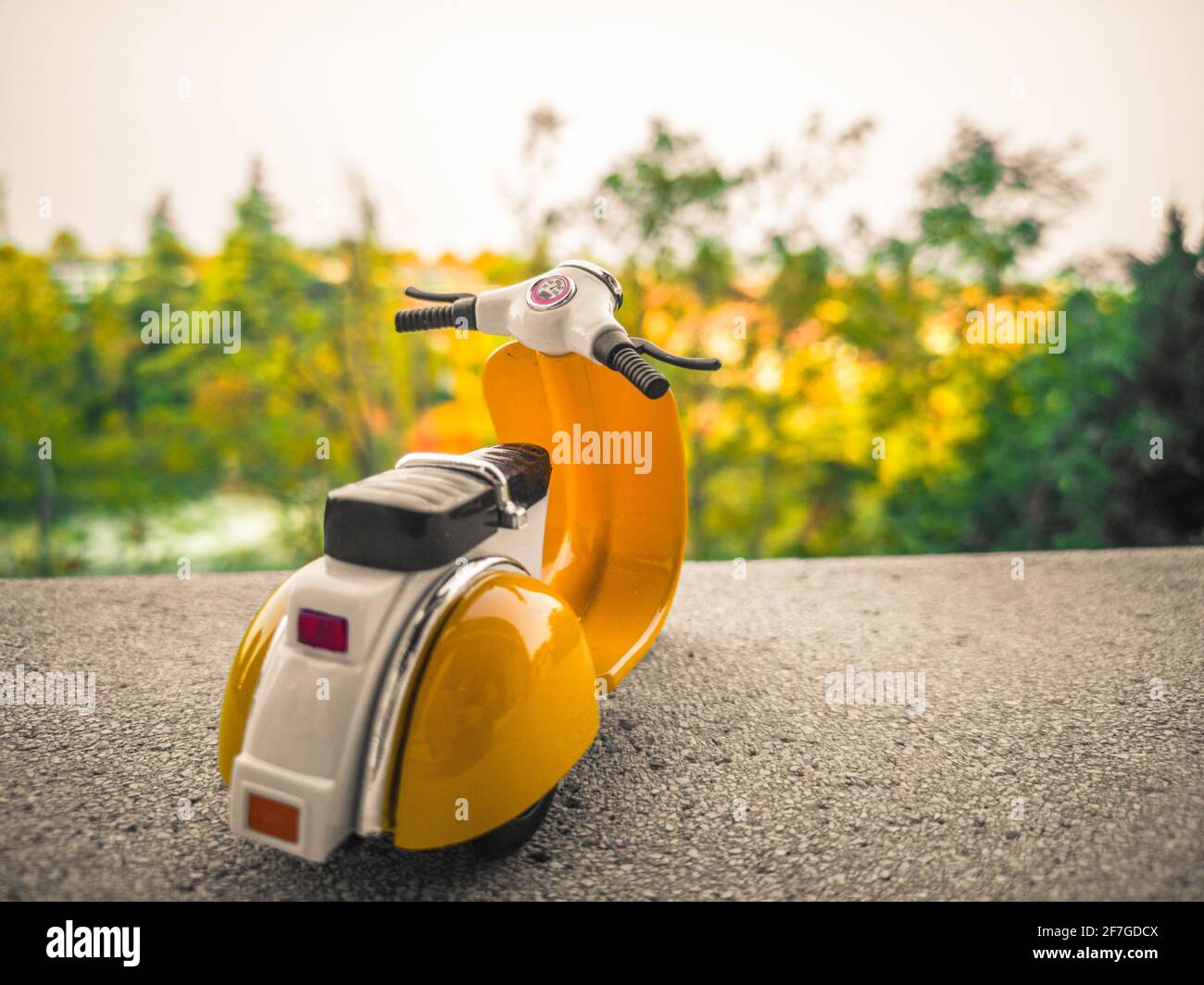background with old toy scooter in vintage Italian style Stock Photo
