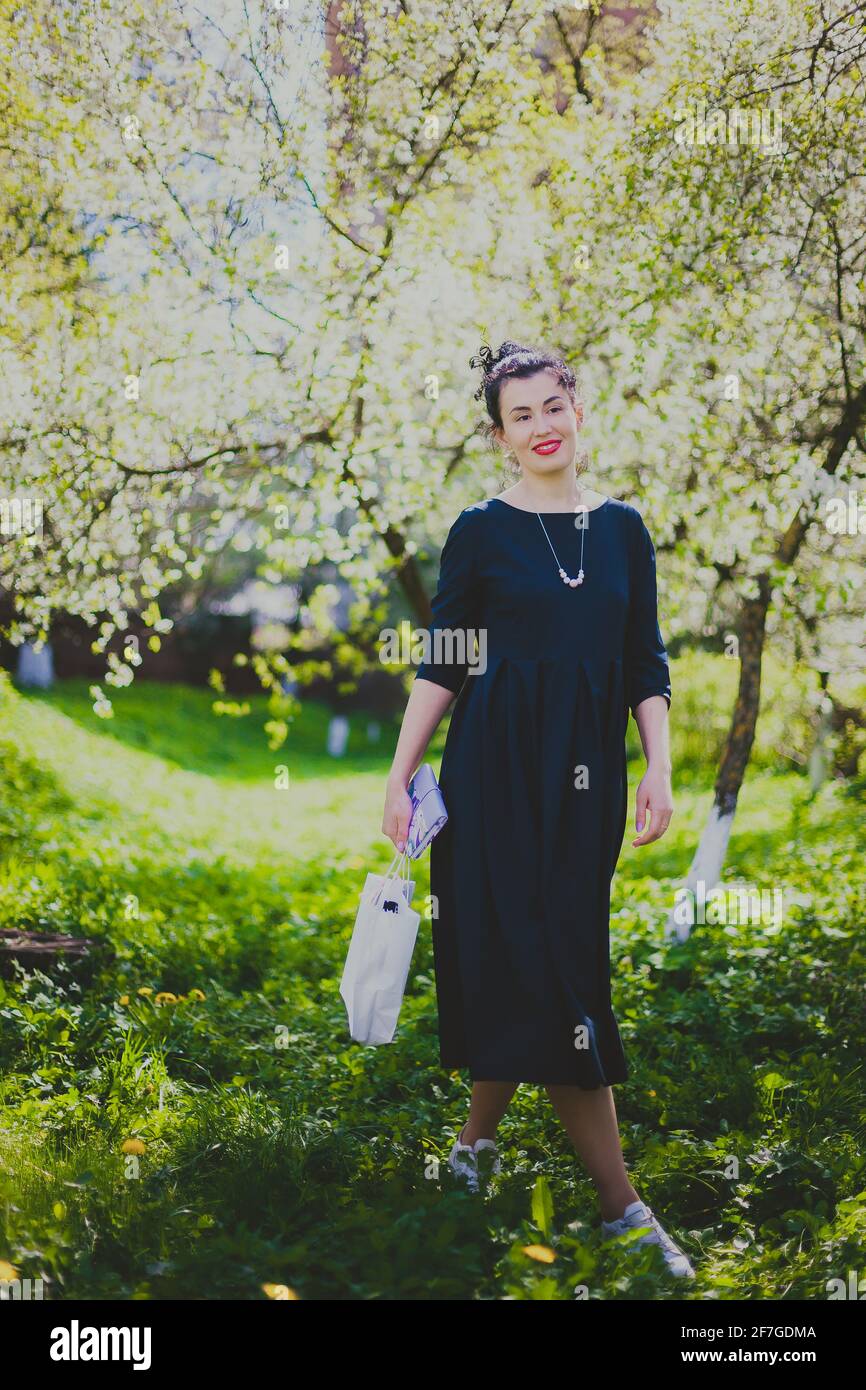 Woman walking cherry blossom in hi-res stock photography and images - Alamy