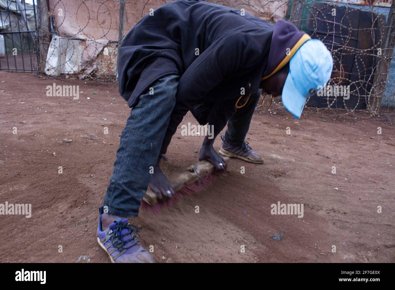 An Informal Illegal gold mine worker Sweeping dust in the streets of the township in Xawela, Carletonville in Johannesburg, South Africa on September 2nd, 2020. (Photo by Manash Das/Sipa USA) Credit: Sipa USA/Alamy Live News Stock Photo