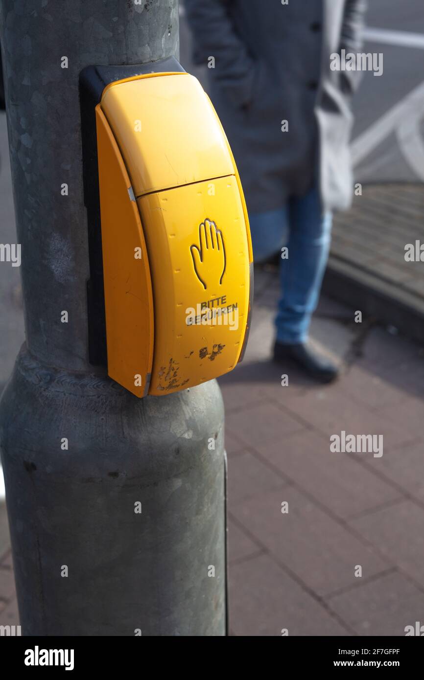 Traffic light button in Cologne Germany. Push it and green light comes Stock Photo