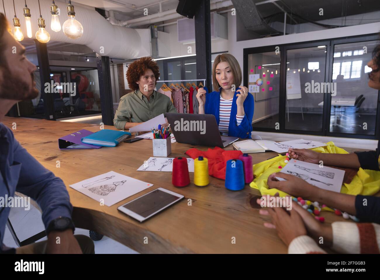 Diverse group of creative fashion designers colleagues brainstorming in meeting room Stock Photo