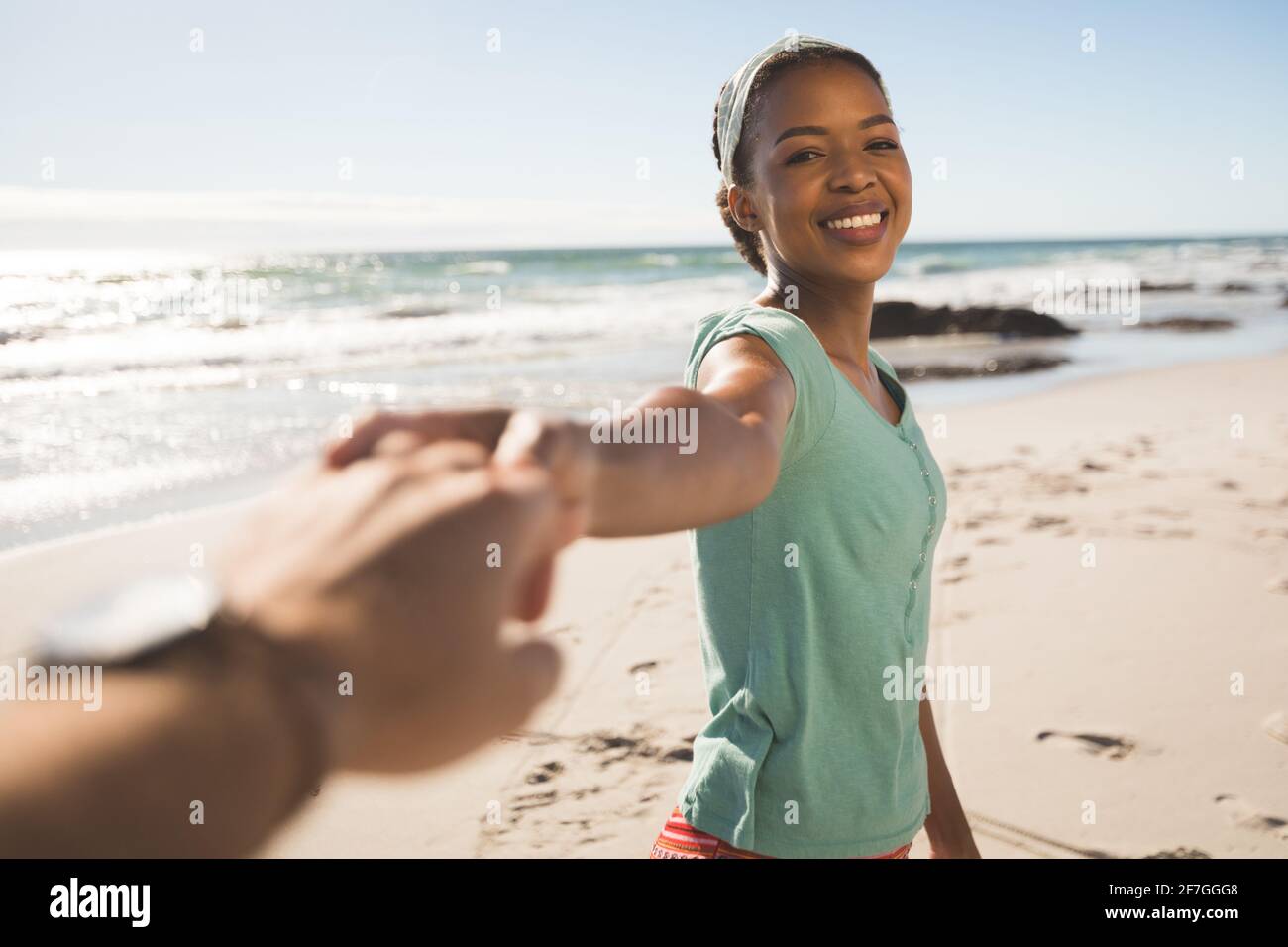Happy african american couple on the beach holding hands Stock Photo ...