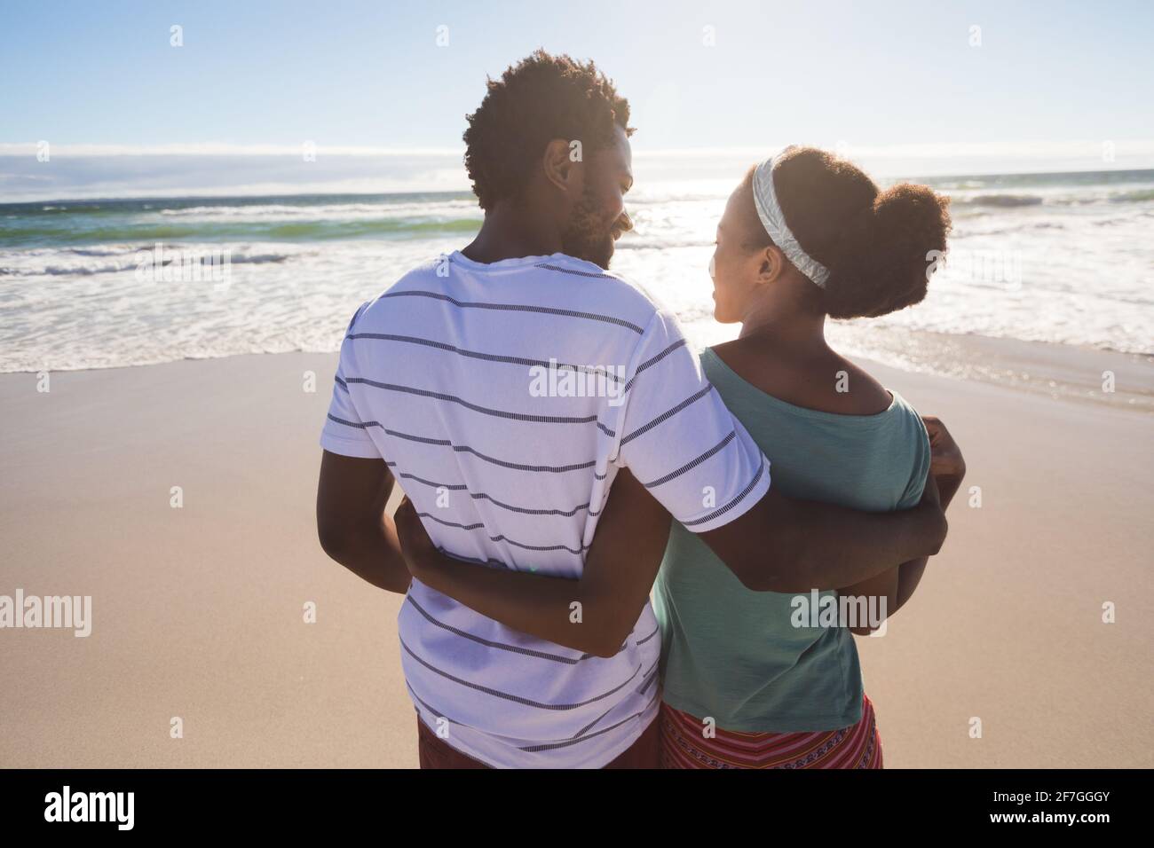 Happy african american couple on the beach embracing Stock Photo - Alamy
