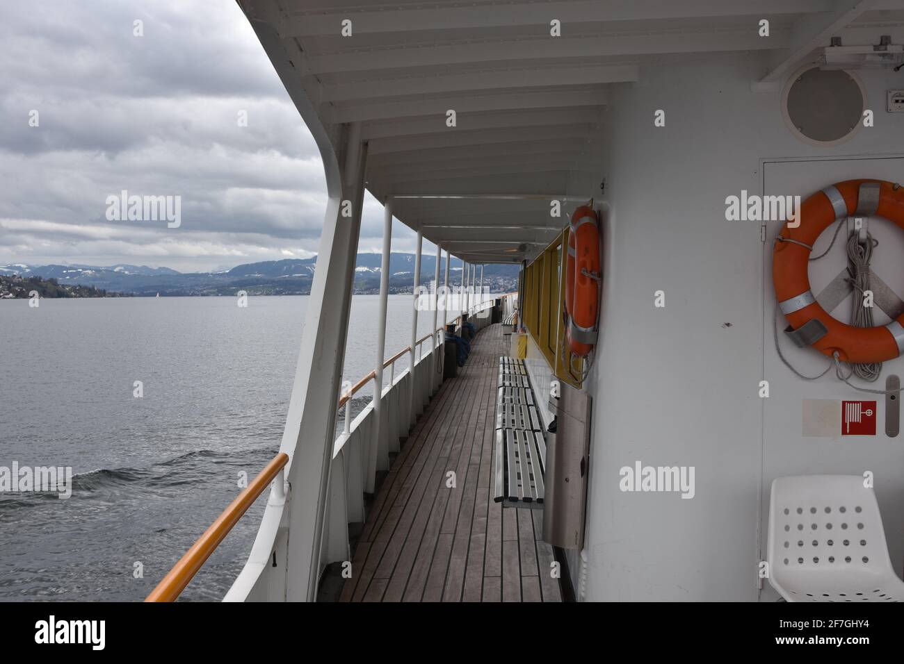 View on main deck from port side, left side, of a tourist motor vessel  painted white on Lake Zurich from Zurich city to Rapperswill. Vessel is empty. Stock Photo