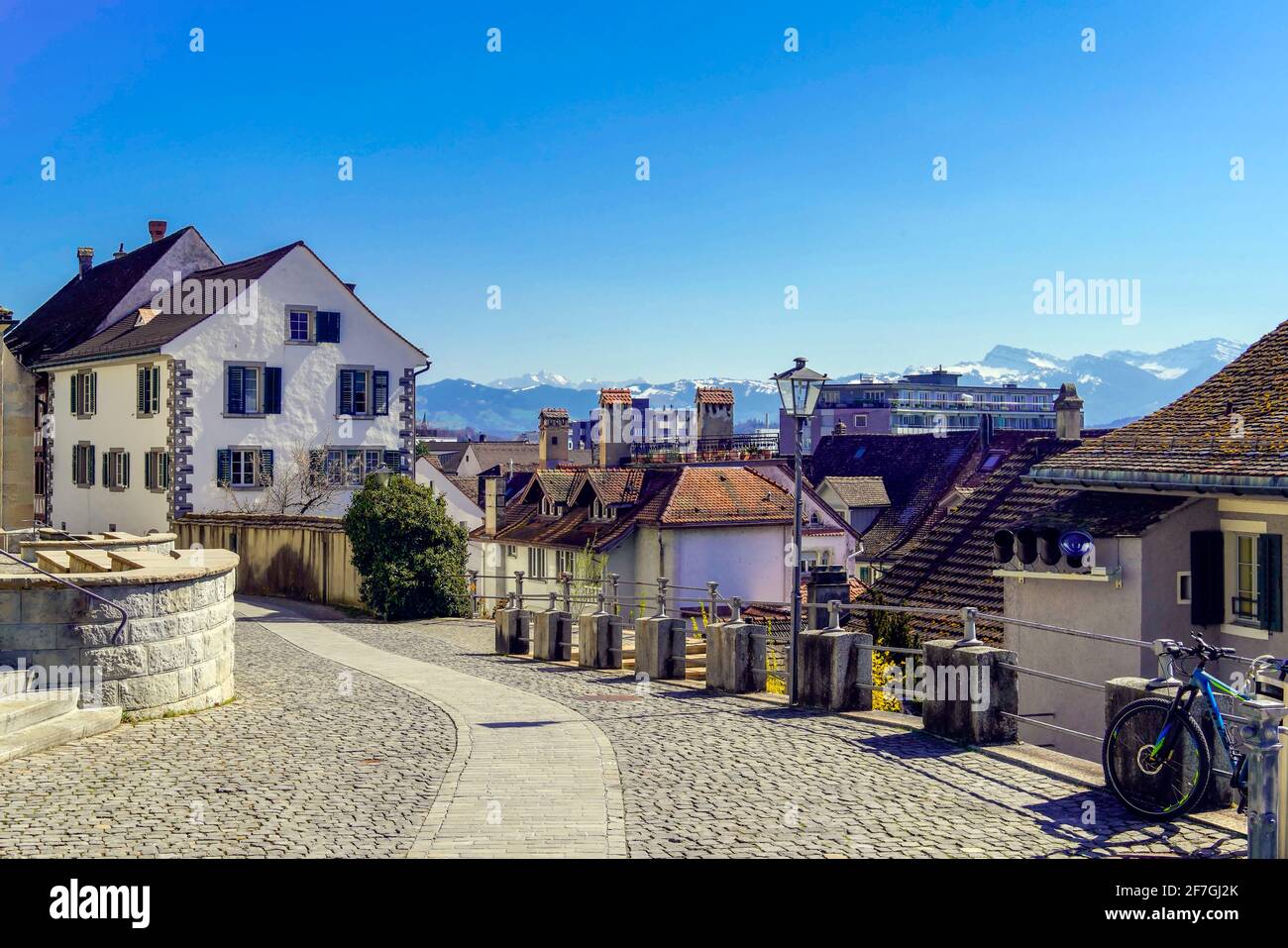 Street in Rapperswil and Alpine landscape. Rapperswil-Jona, Canton of St. Gallen, Switzerland. Stock Photo