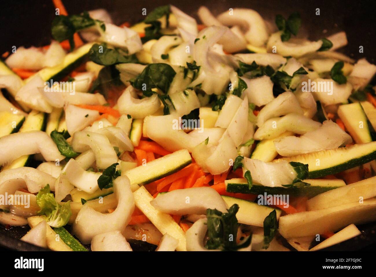 Close-up of a pile of chopped vegetables, including carrot, onion, Bok choy, celery. Stock Photo