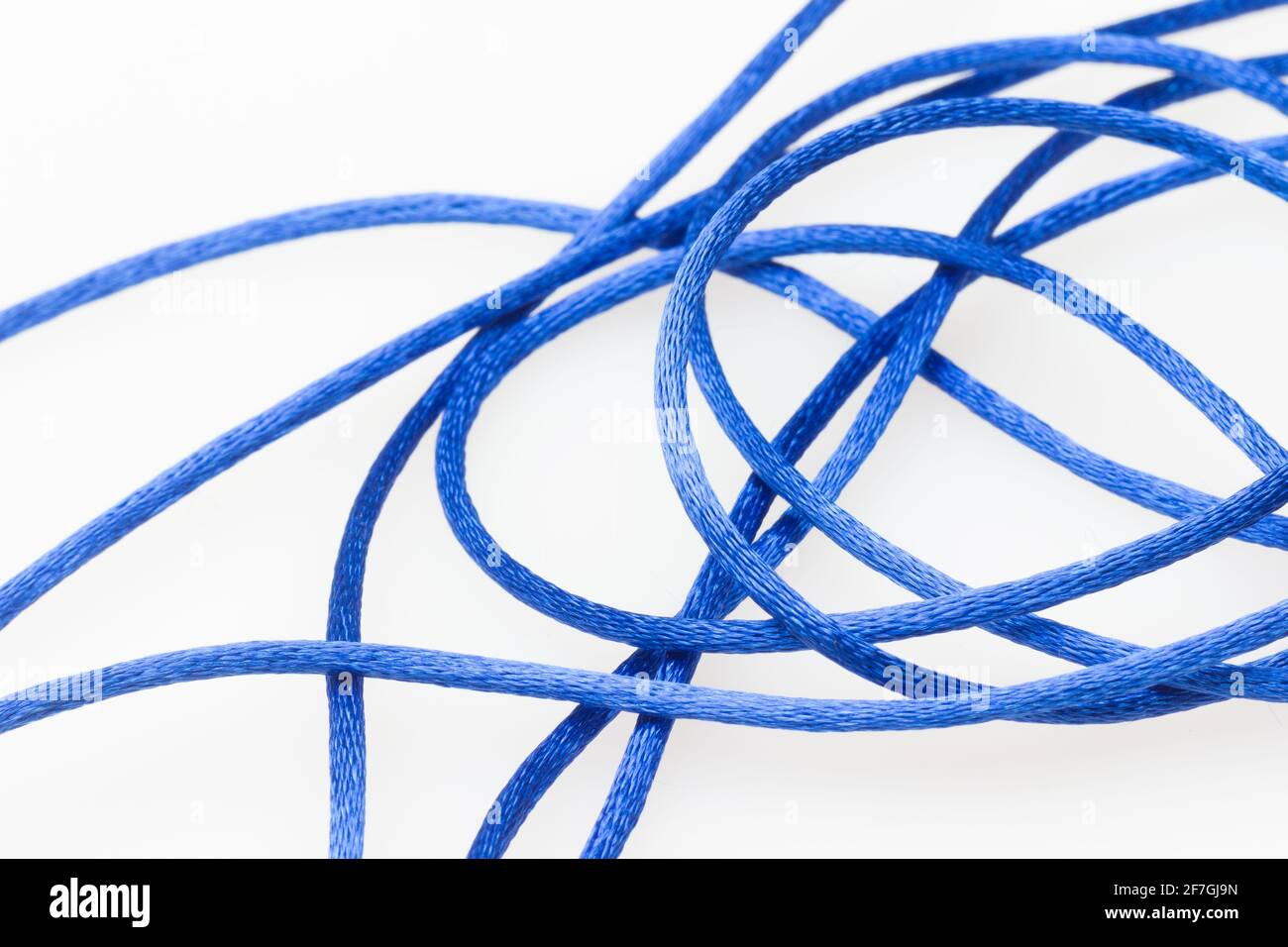 blue messy string, string out of coil a bit messy; blue string on white  background Stock Photo - Alamy
