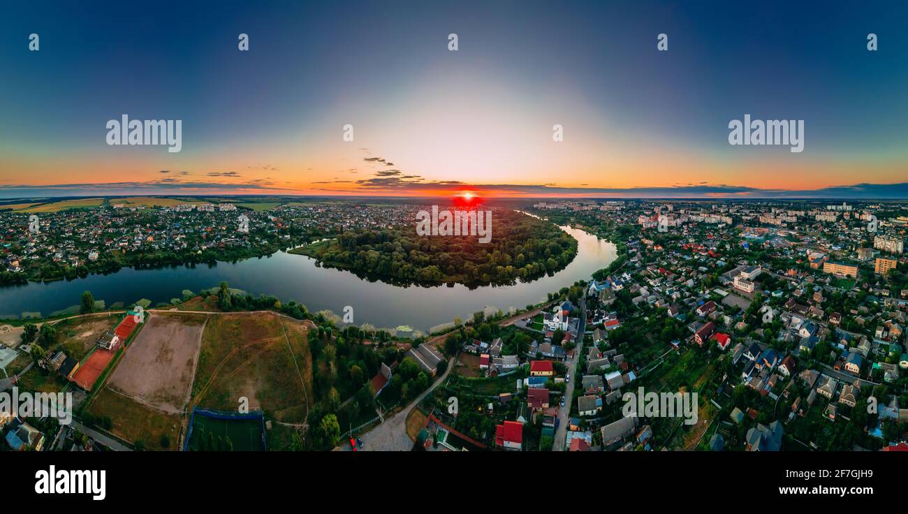 Aerial panoramic view of of small european city placed on river banks at summer sunny day with clouds, Kyiv region, Ukraine Stock Photo